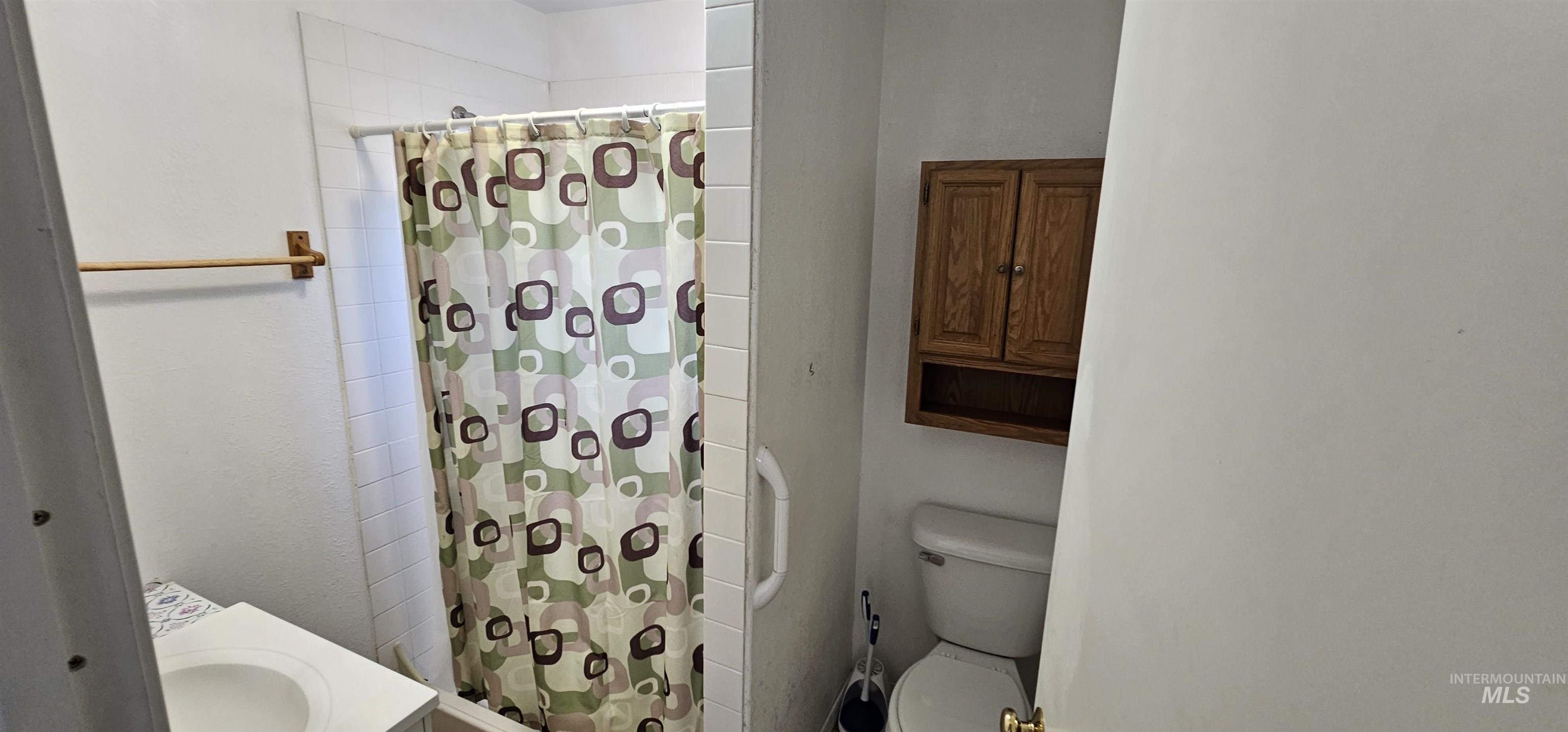 Full bath featuring a stall shower and vanity