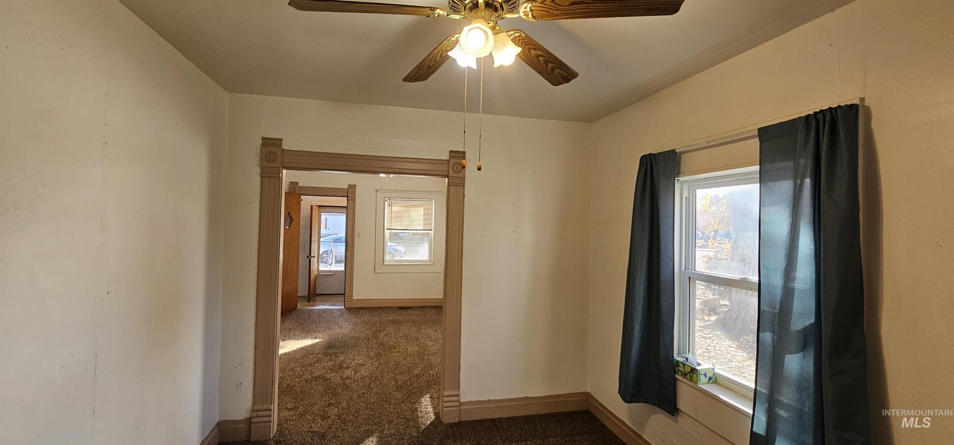 Spare room featuring baseboards and a ceiling fan