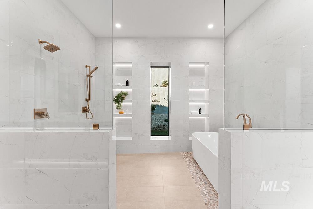 Bathroom featuring a freestanding bath, a marble finish shower, light tile patterned floors, tile walls, and recessed lighting