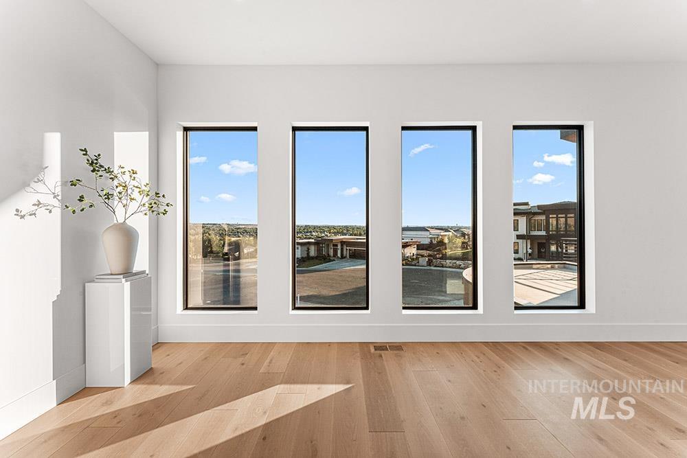 Doorway with wood finished floors and baseboards