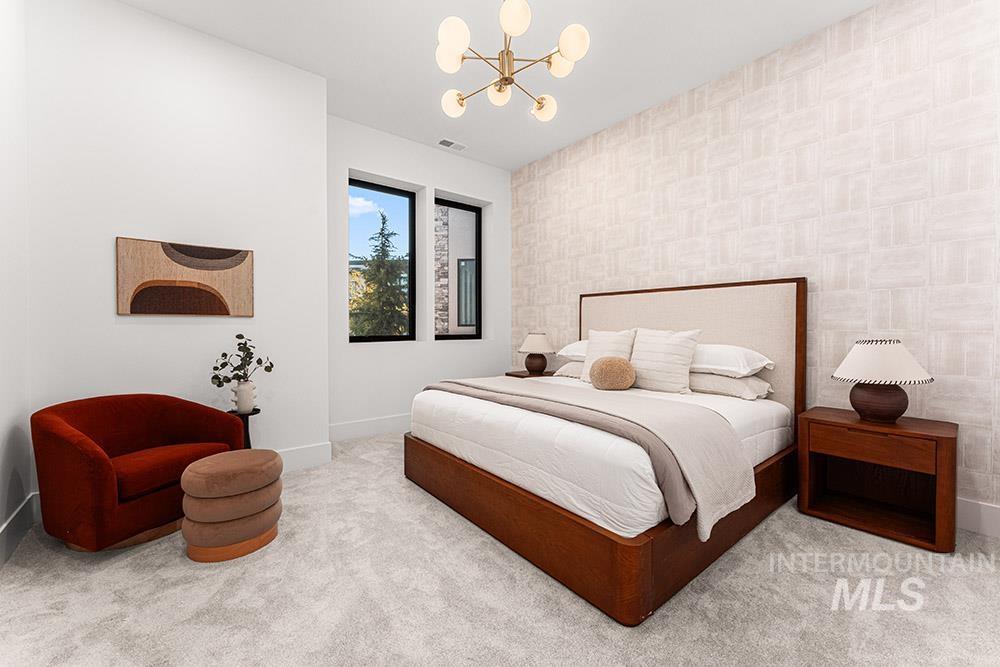 Bedroom featuring a chandelier, carpet floors, and wallpapered walls