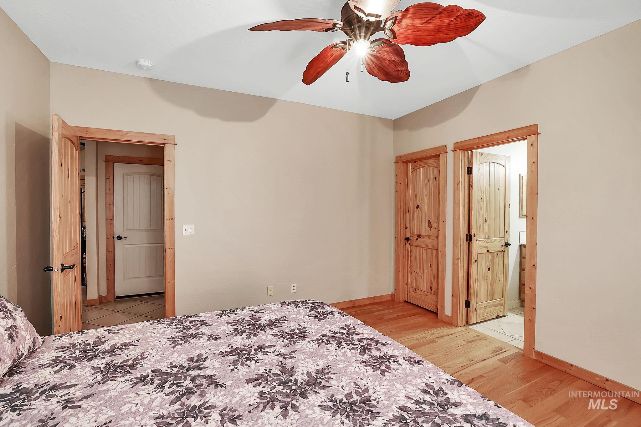 Bedroom with light wood-style flooring and ceiling fan