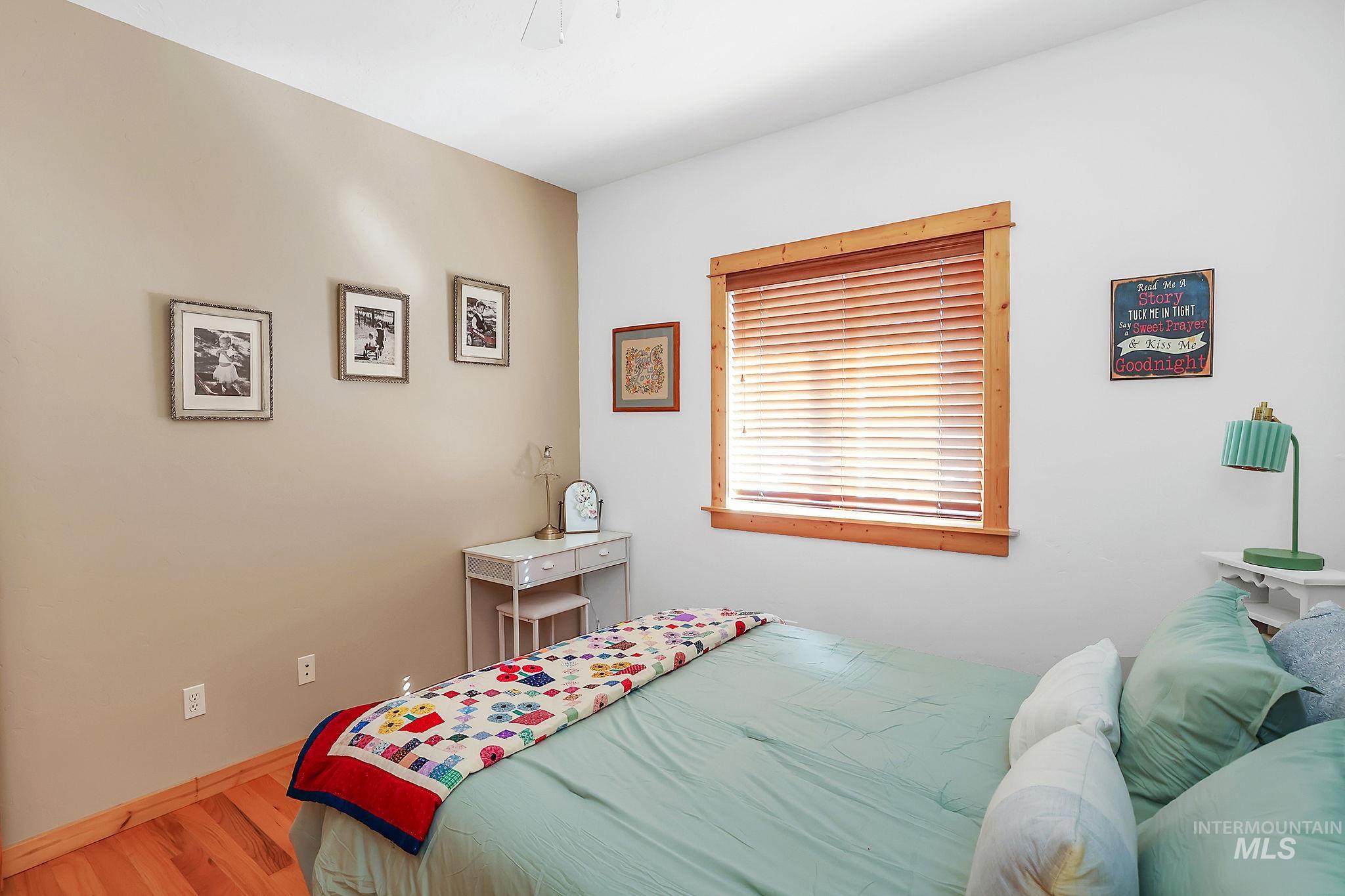 Bedroom with light wood-type flooring and a ceiling fan
