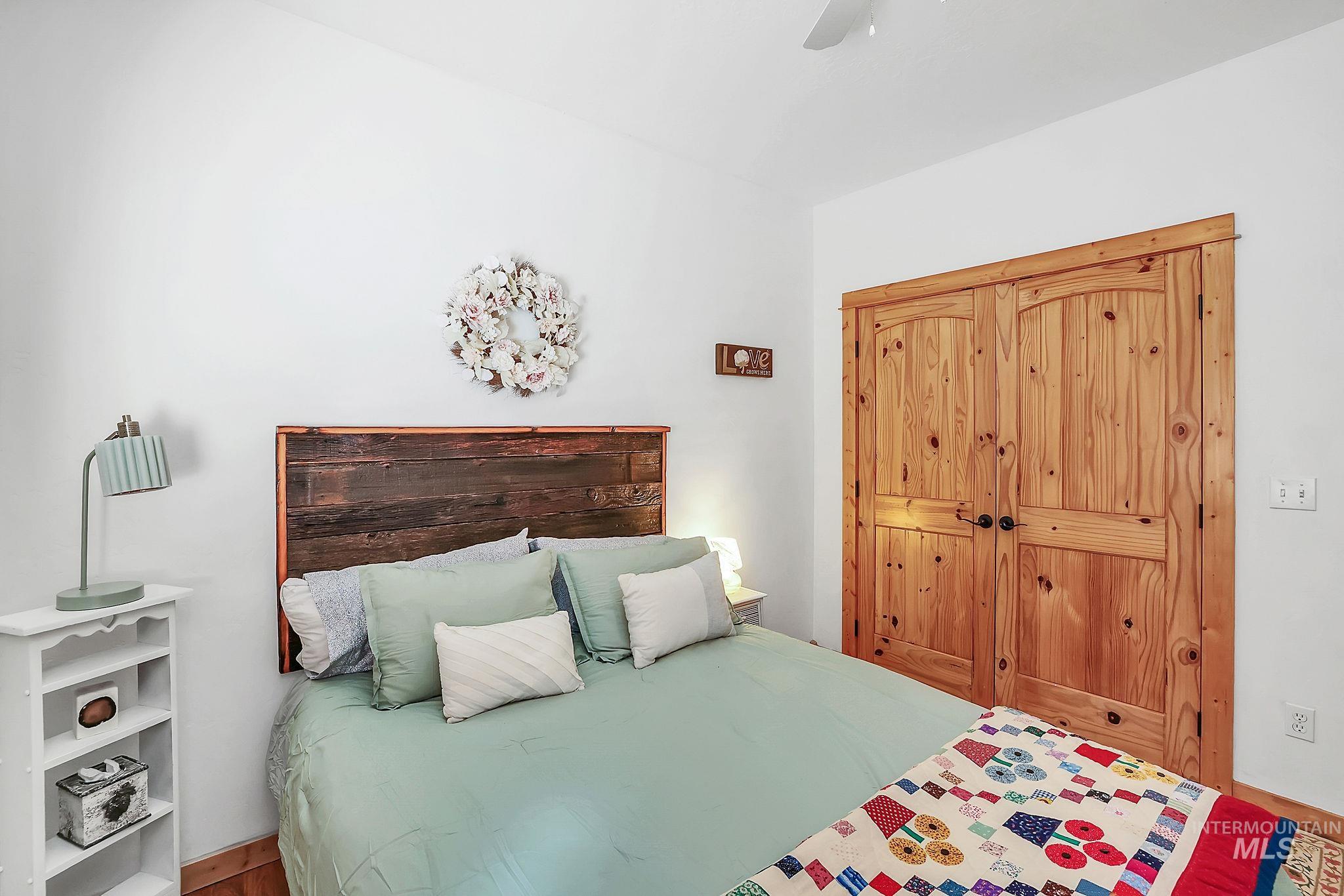 Bedroom featuring a closet, ceiling fan, and wood finished floors