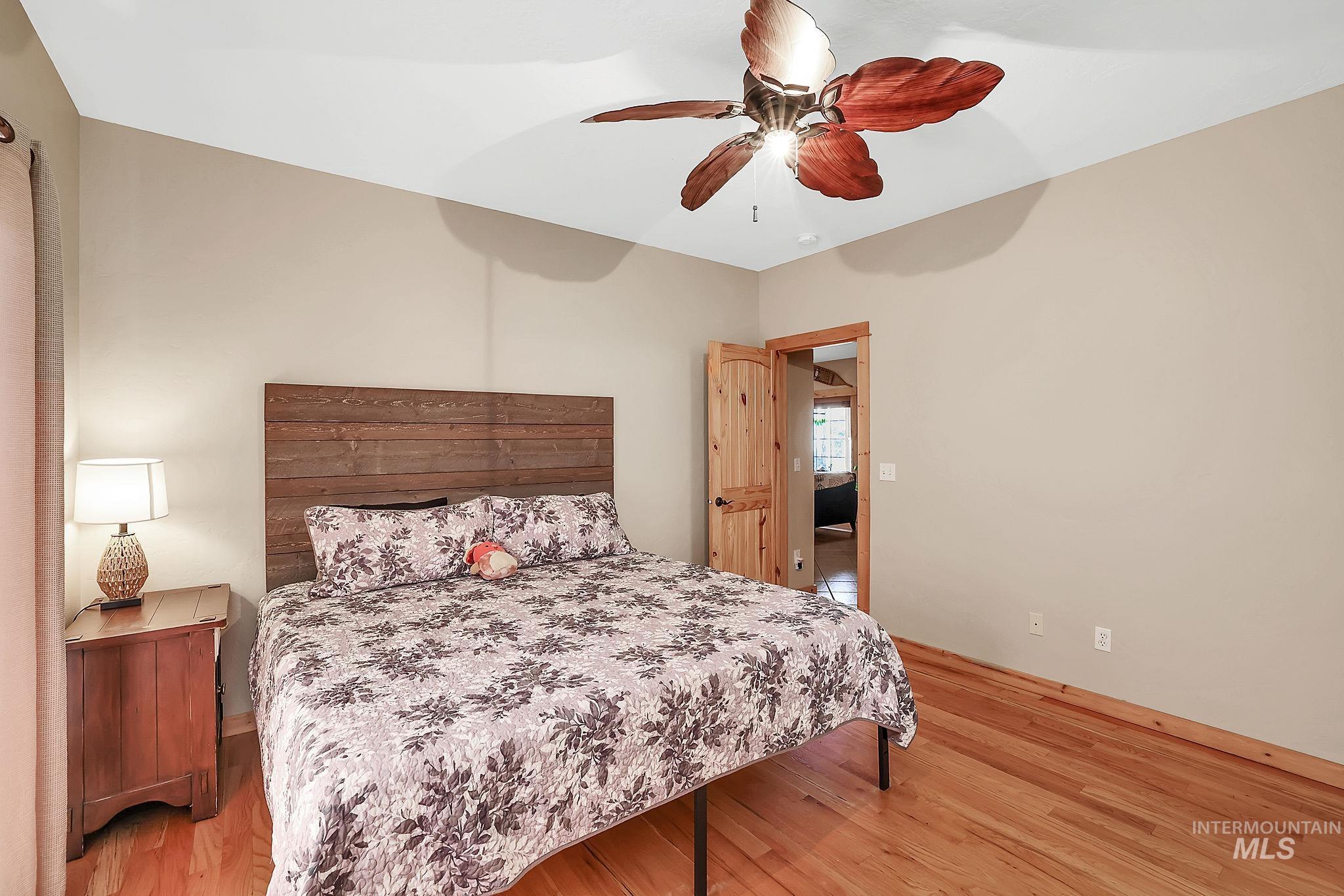 Bedroom with light wood-style floors and ceiling fan