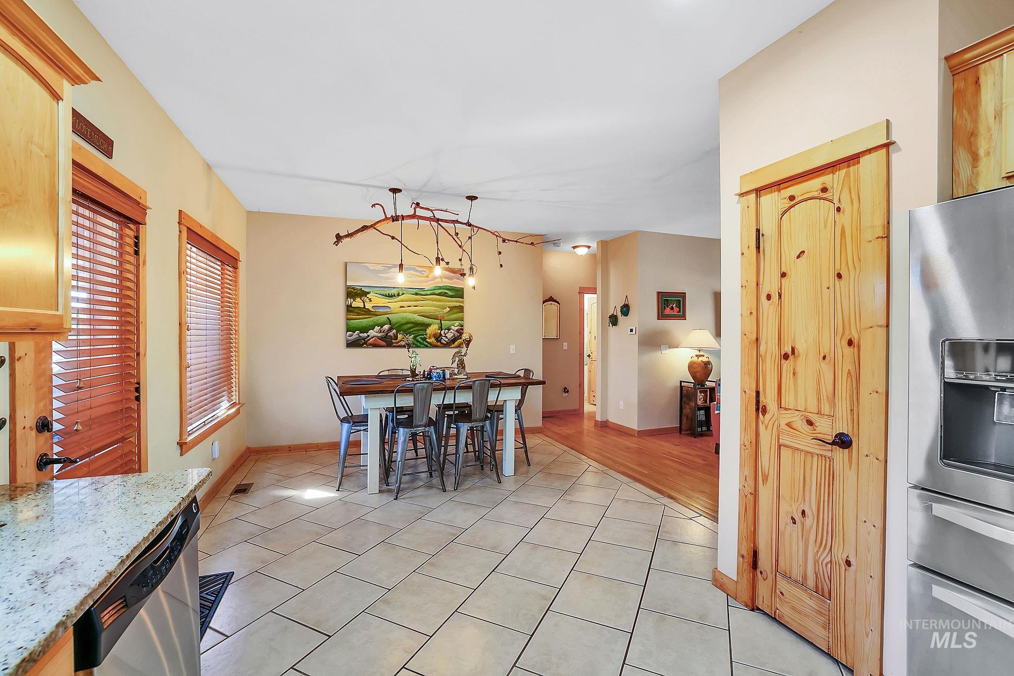 Dining space with light tile patterned flooring