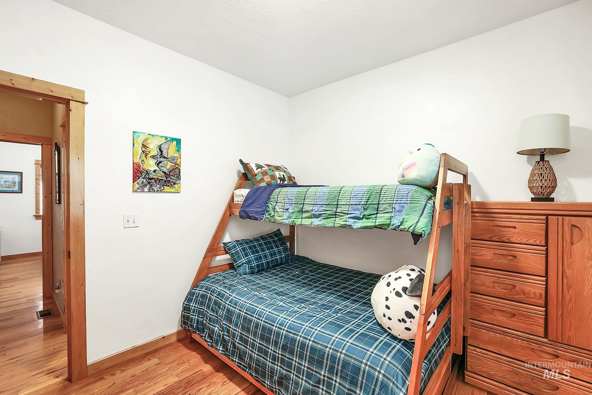 Bedroom with light wood-style flooring and baseboards