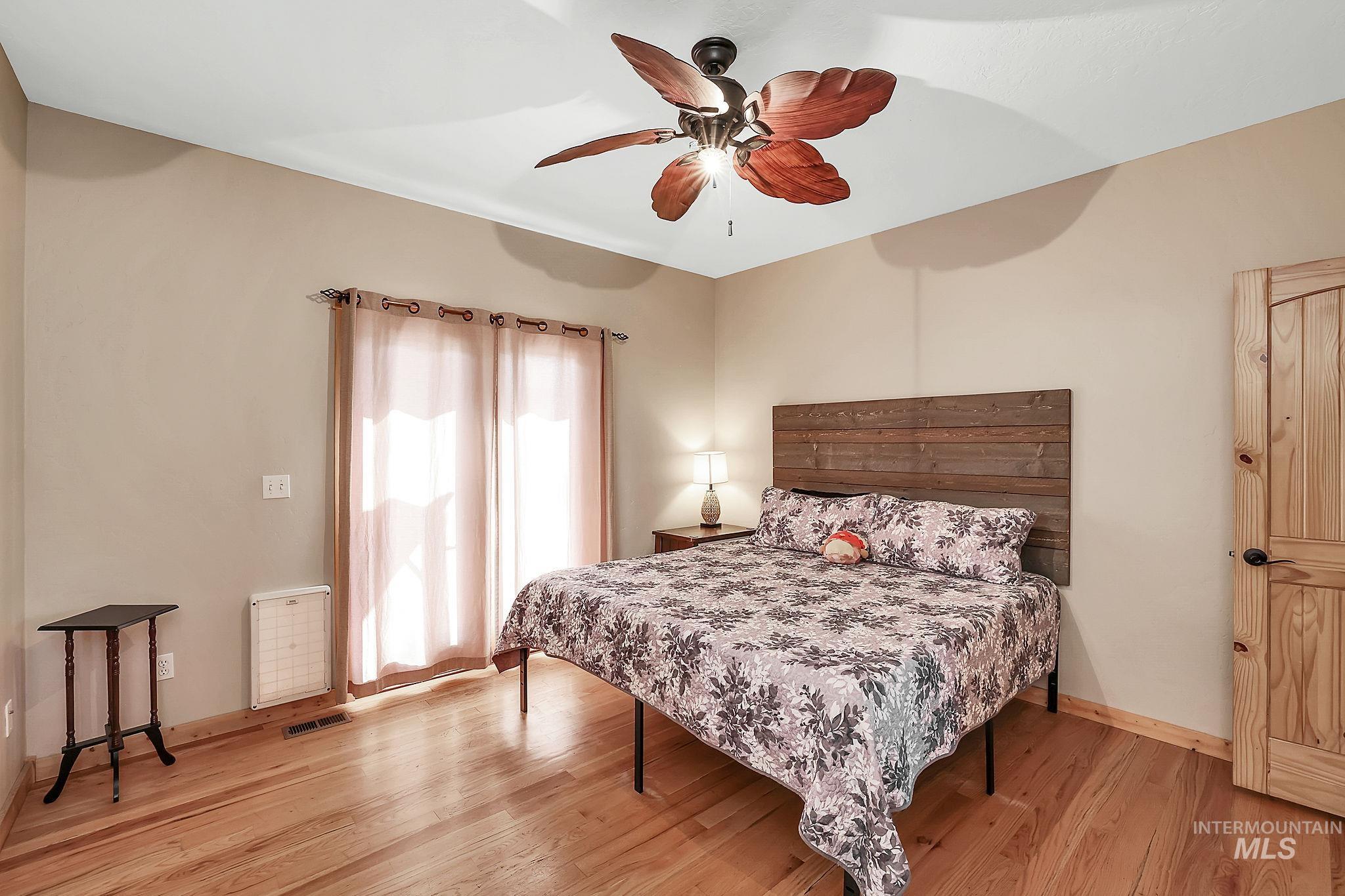 Bedroom featuring ceiling fan and light wood-type flooring