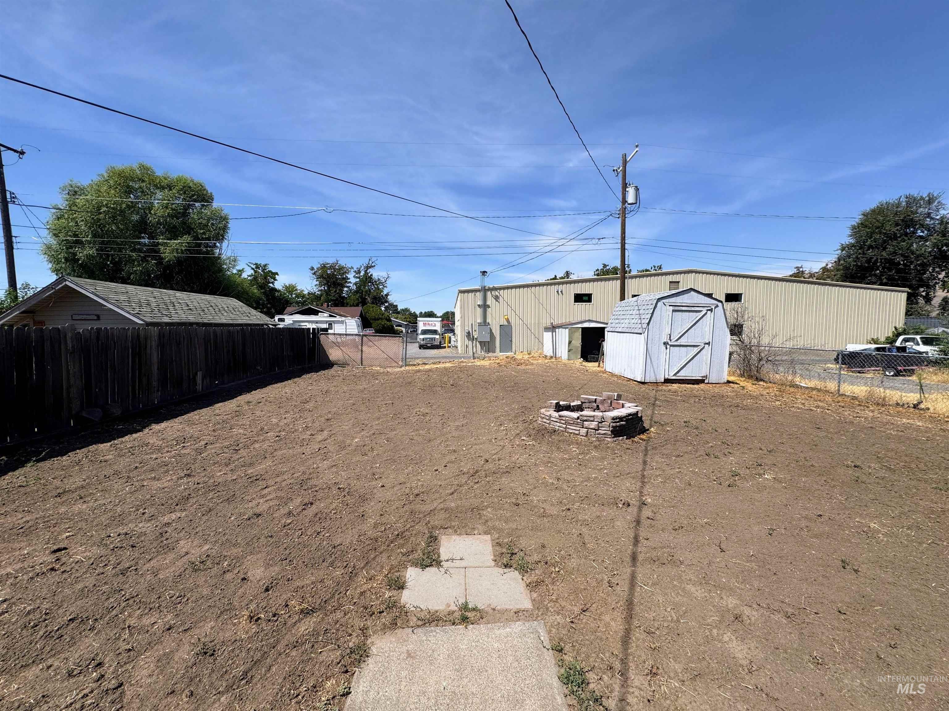 View of yard with a storage unit