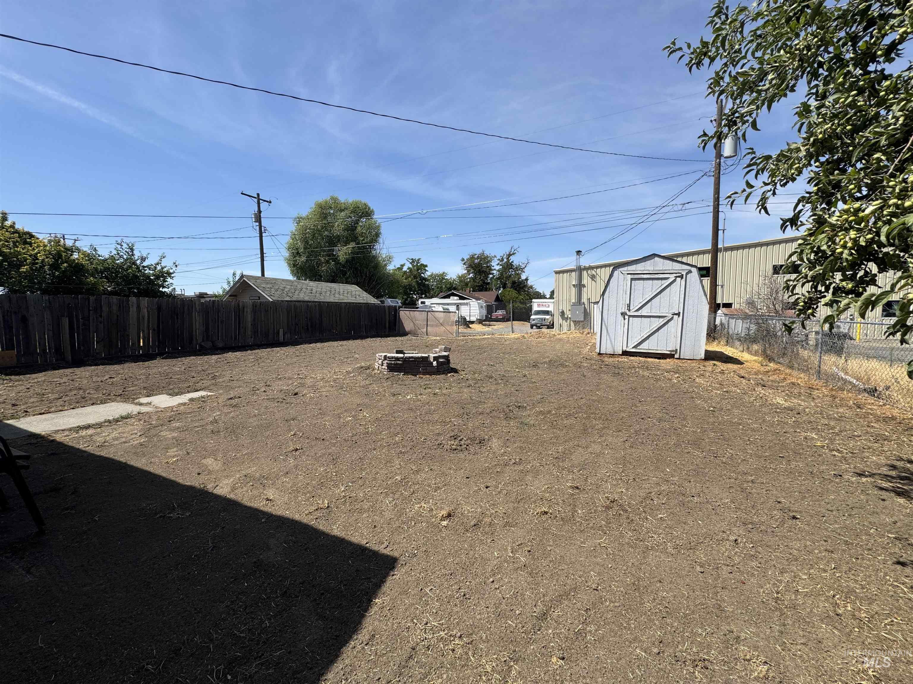 Fenced backyard with a storage shed