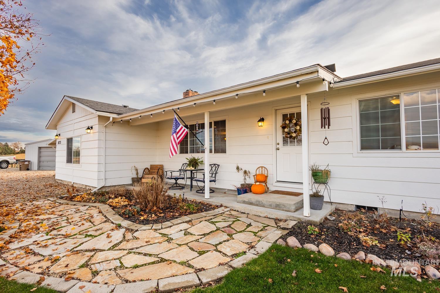 Rear view of property with a porch and a chimney