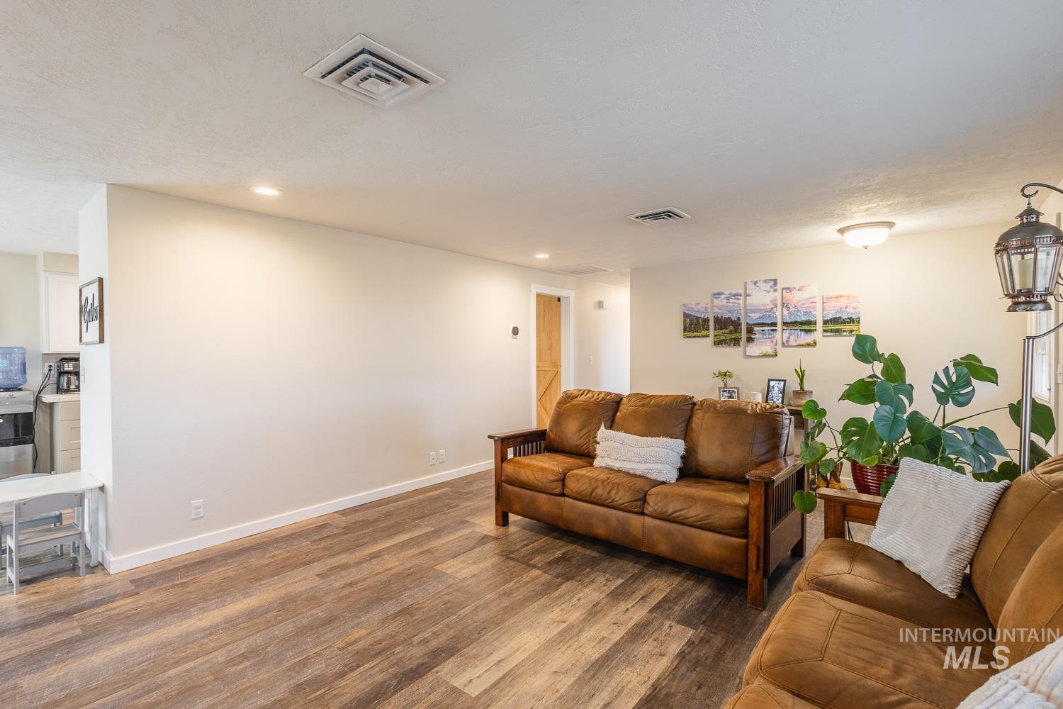 Living area with wood finished floors and recessed lighting