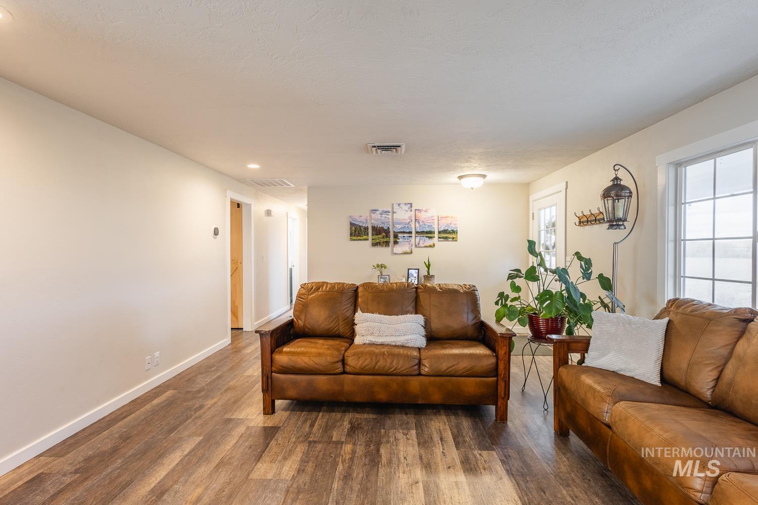 Living room with wood finished floors and recessed lighting