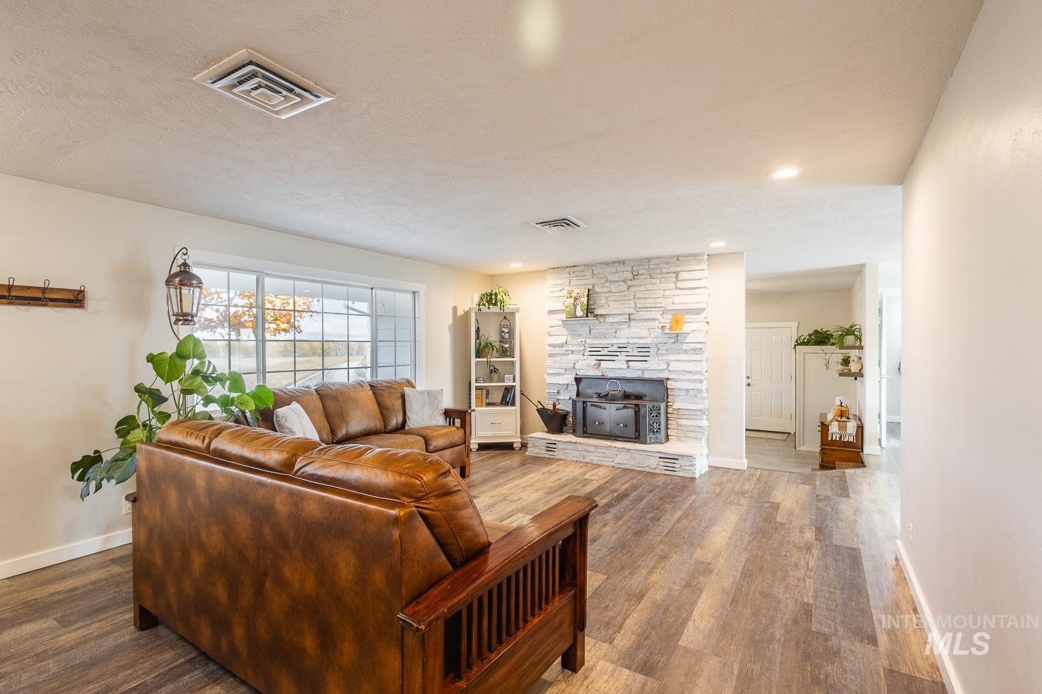 Living area with wood finished floors and recessed lighting