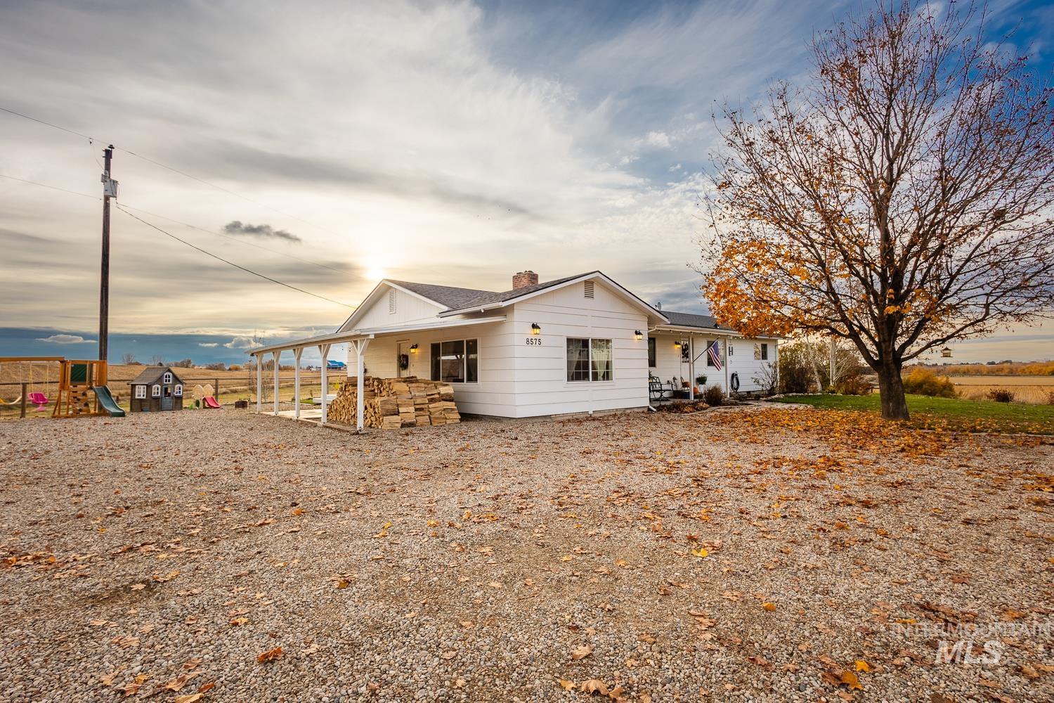 View of front facade with a chimney and a playground