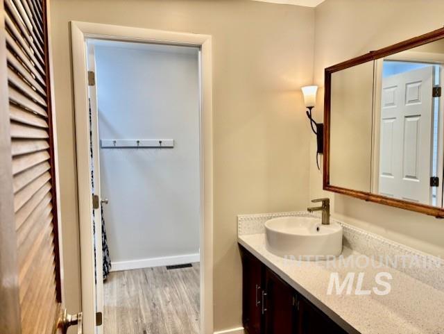 Bathroom featuring vanity and light wood finished floors