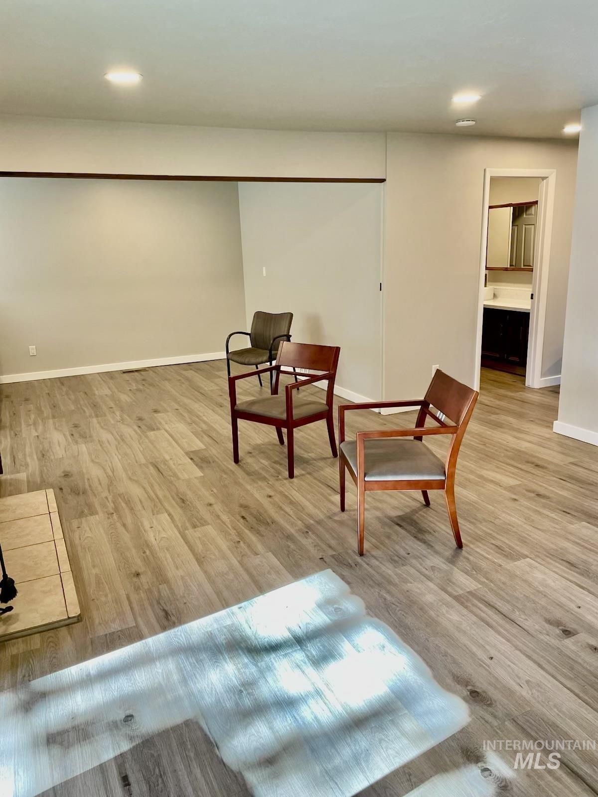 Living area with recessed lighting and light wood finished floors