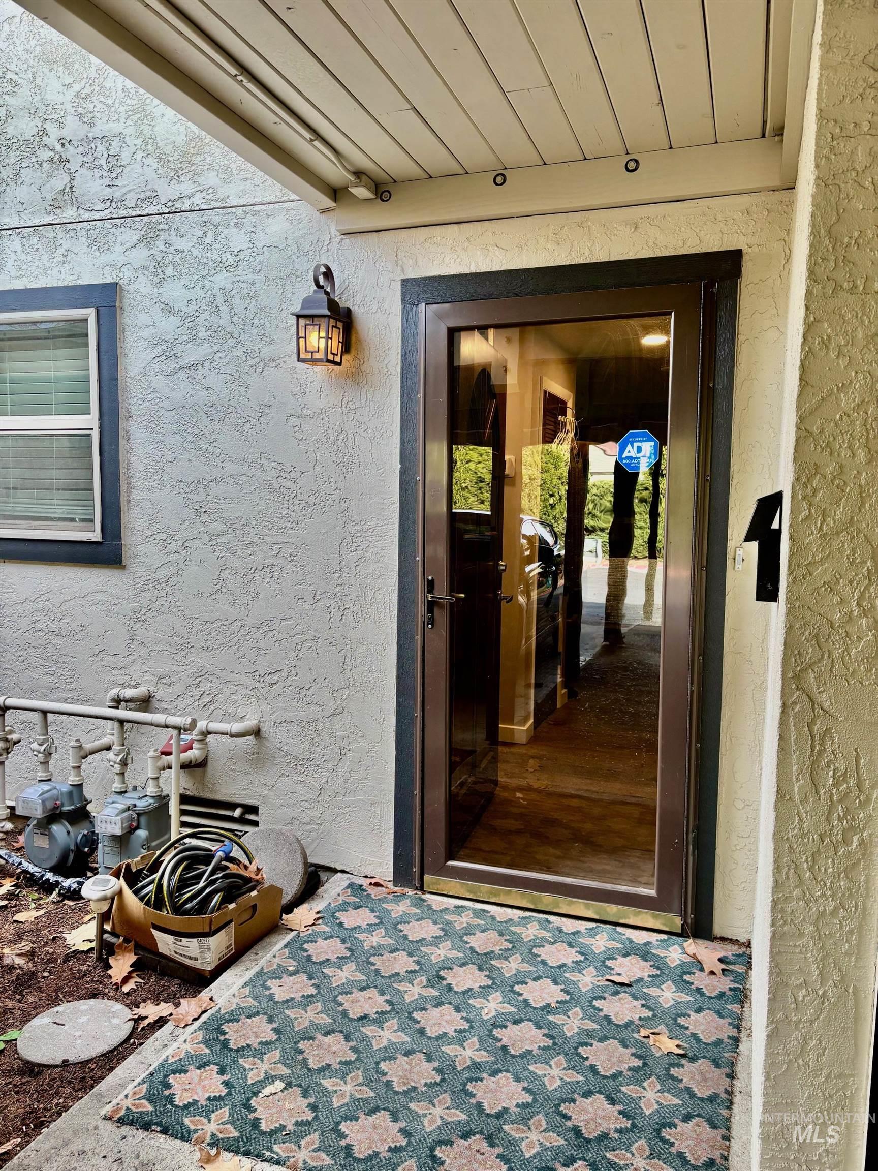 Property entrance with stucco siding