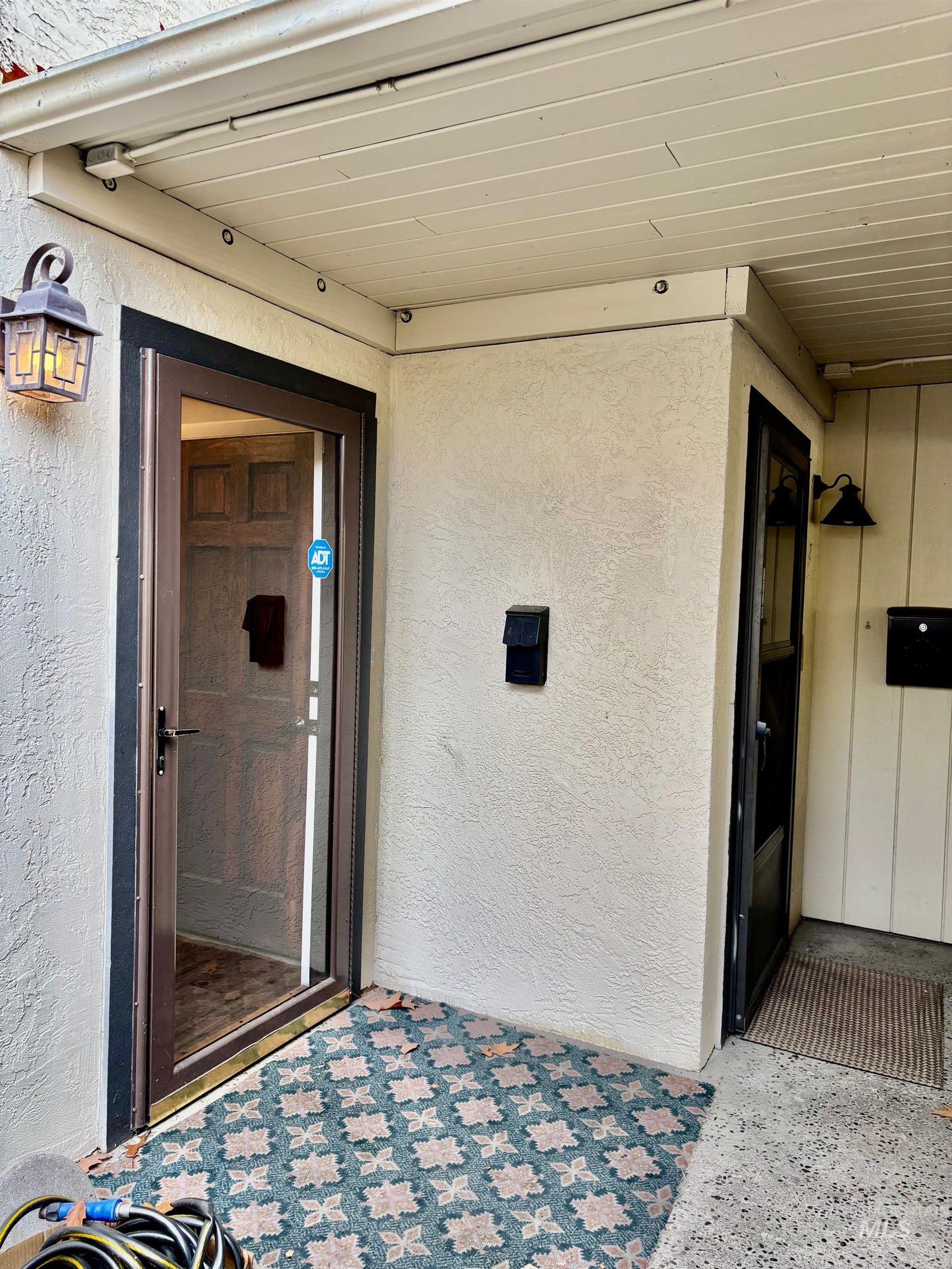 Entrance to property with stucco siding