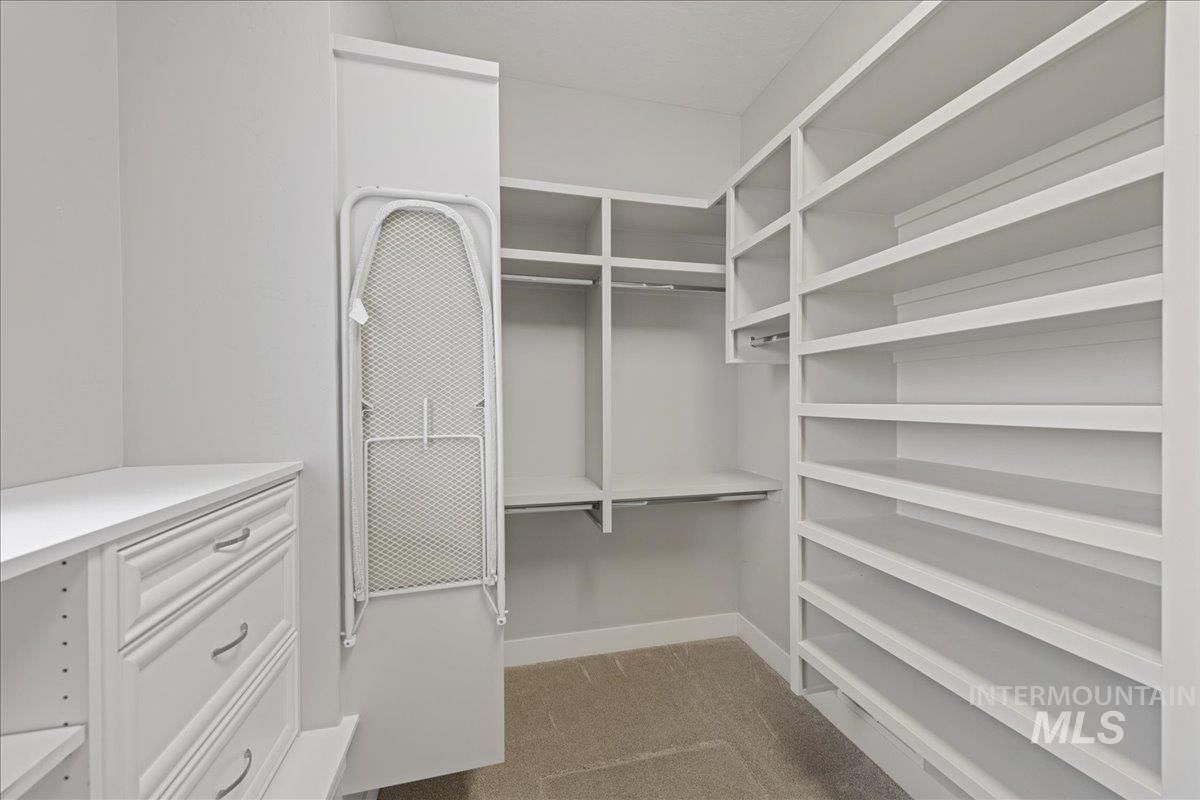 Spacious closet with light carpet