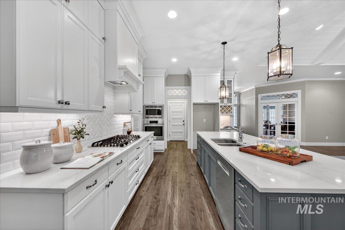 Kitchen featuring decorative backsplash, white cabinets, french doors, dark wood-style flooring, and recessed lighting