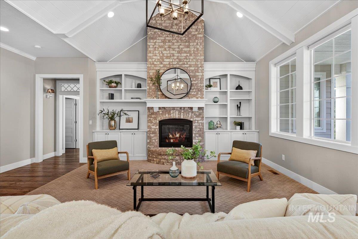 Living area with a chandelier, a fireplace, and recessed lighting