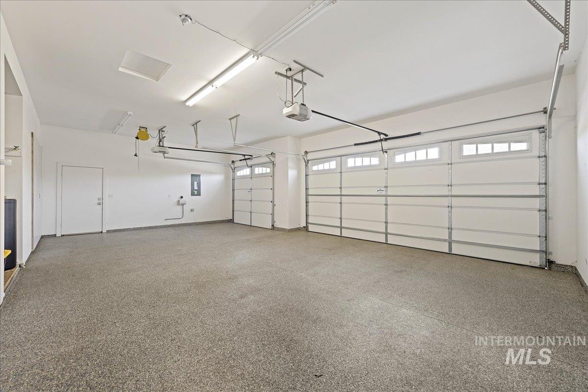 Garage with electric panel and a garage door opener