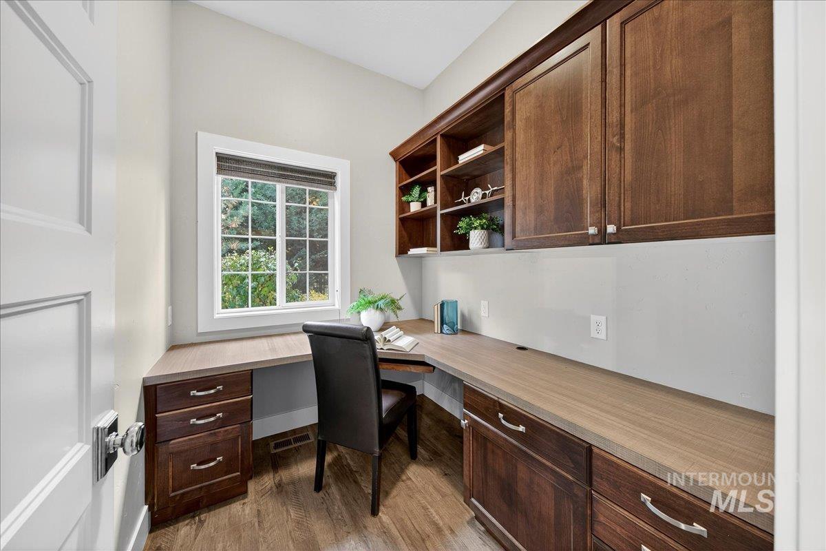 Office space featuring built in study area and light wood-type flooring
