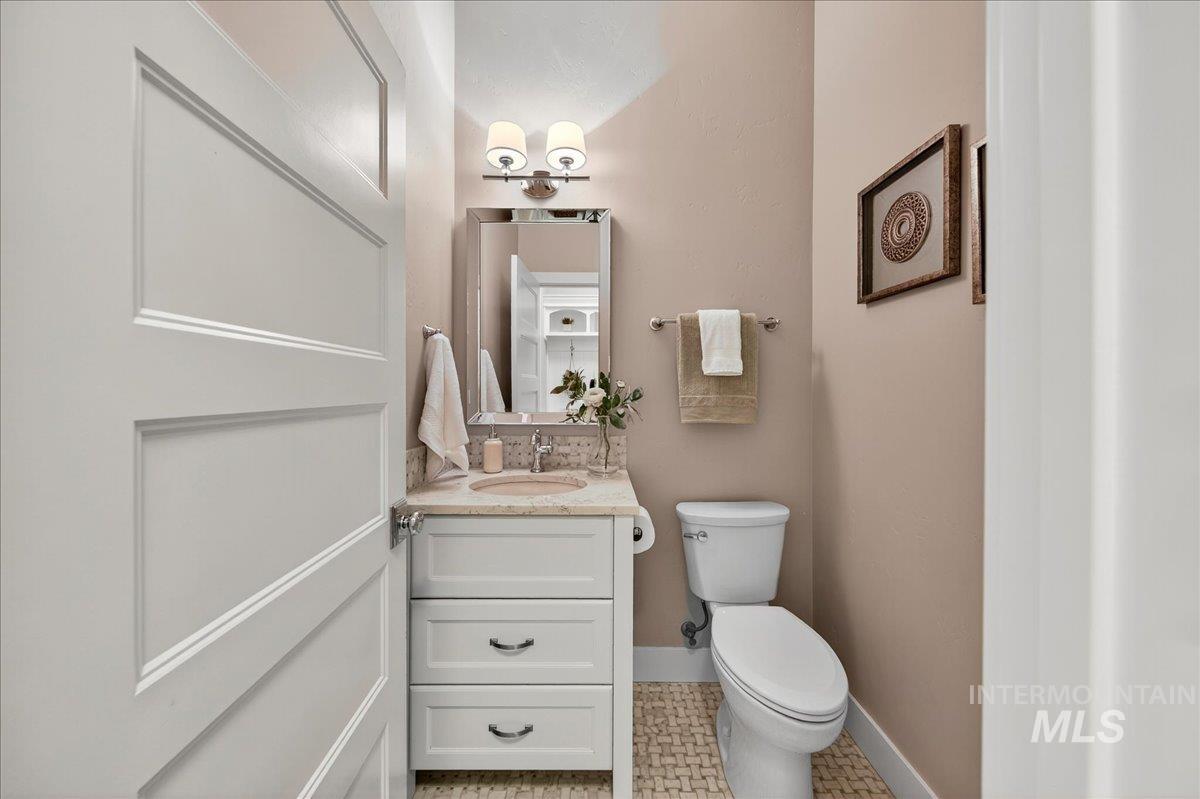 Half bathroom with vanity and light tile patterned floors