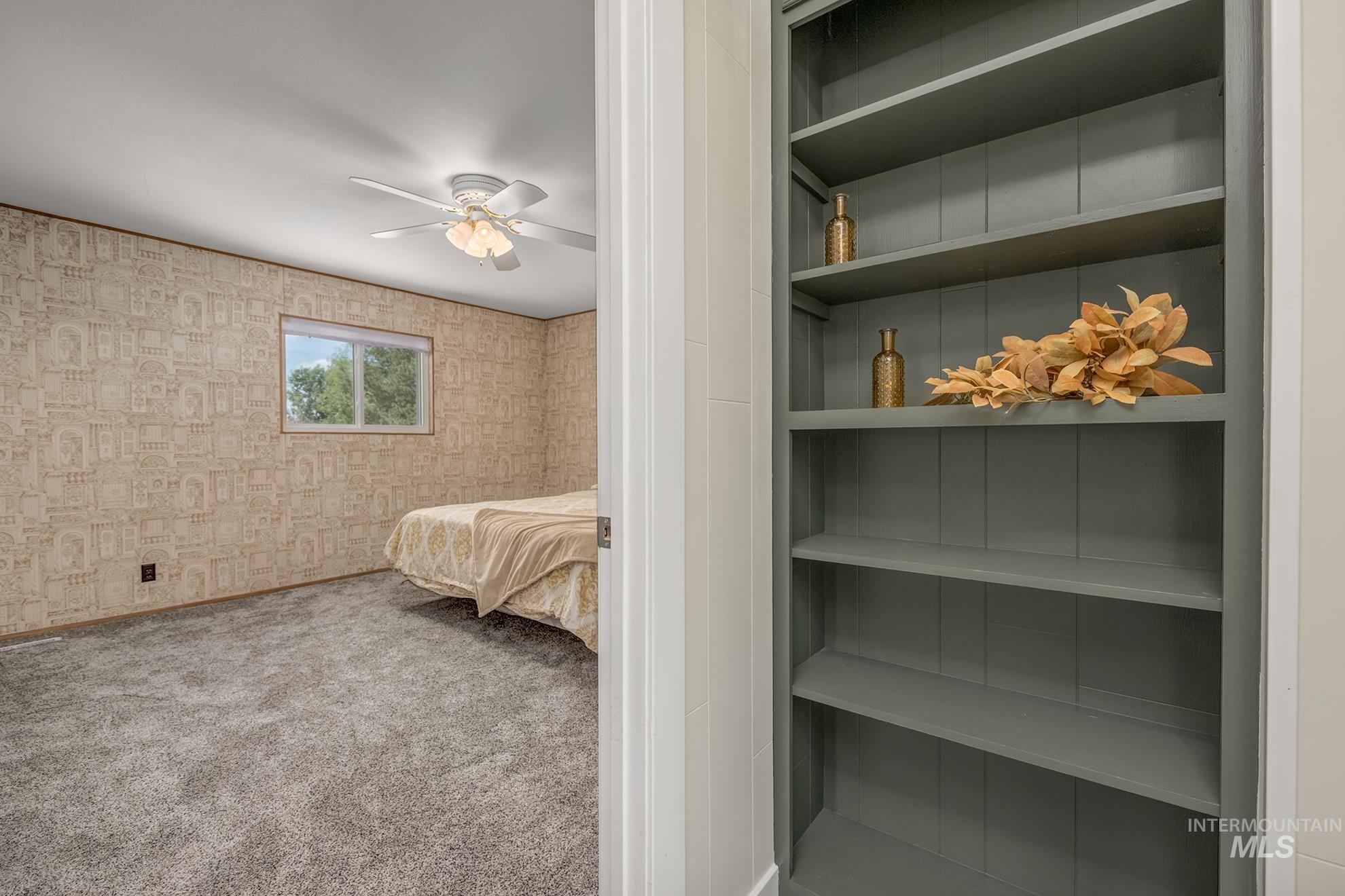 Built-in shelving with a rich slate finish, offering integrated storage