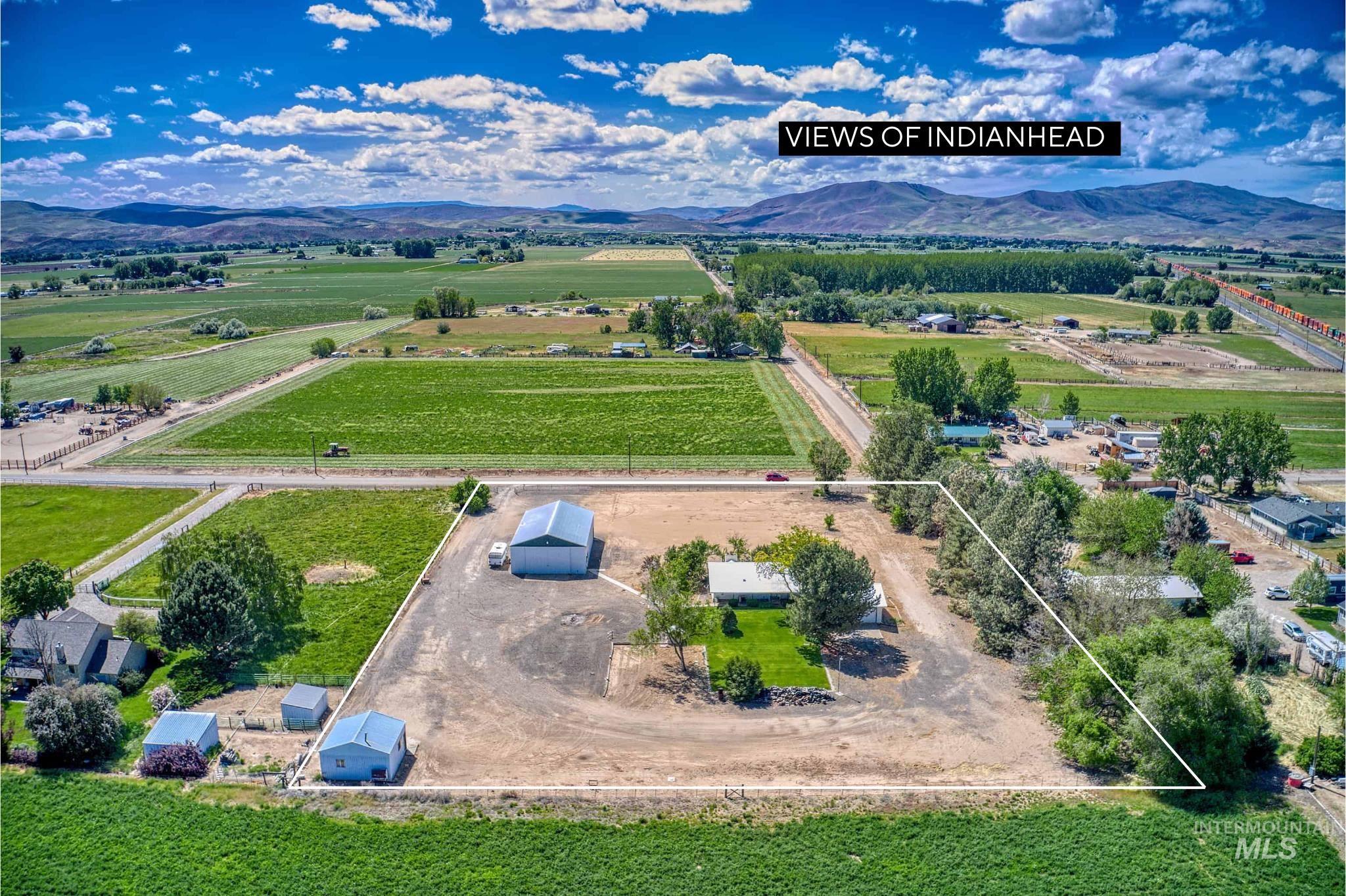 Expansive property with multiple outbuildings, including a large metal barn and two smaller sheds