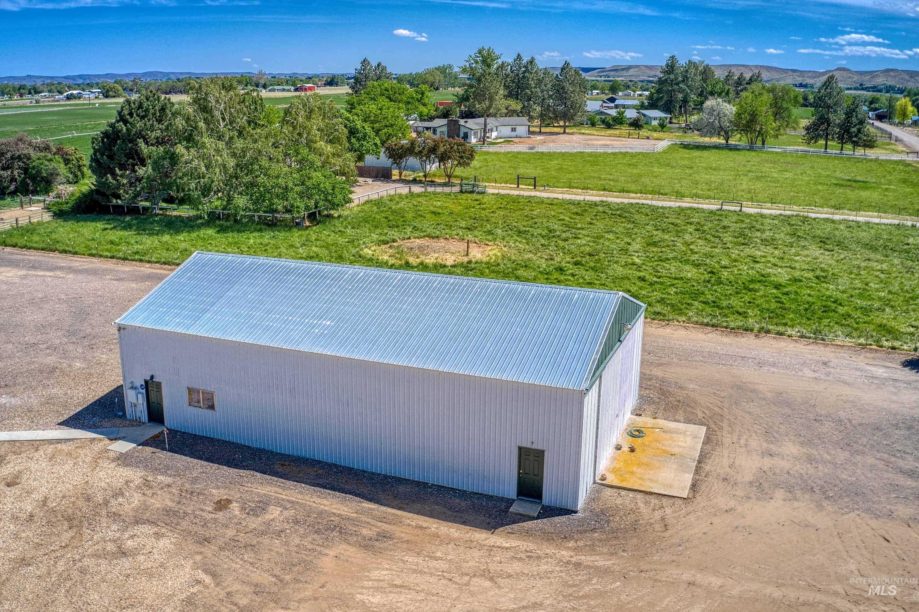 Large metal building featuring a corrugated metal roof and white siding
