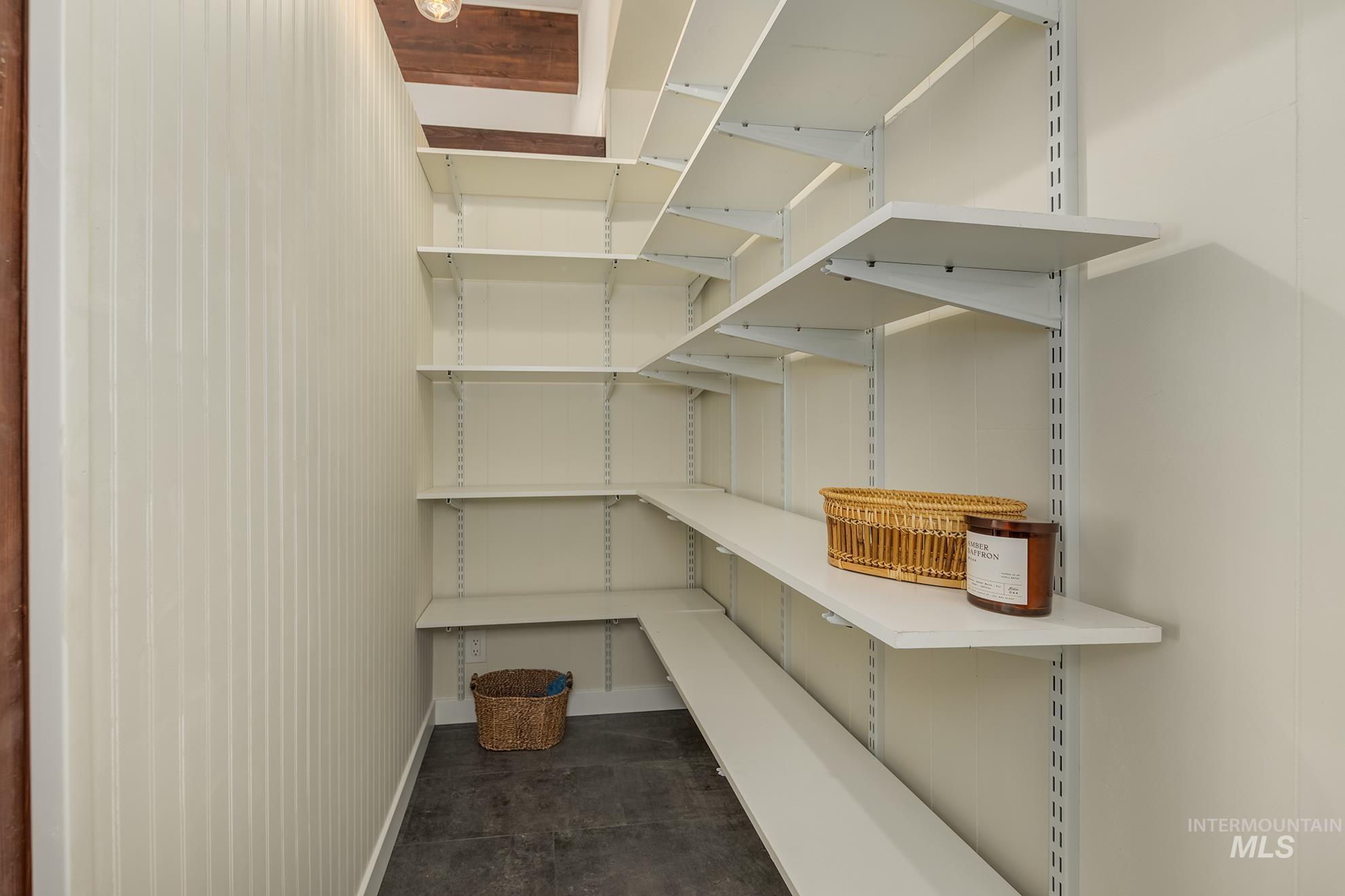 Adjustable wall-mounted shelving system featuring multiple white shelves