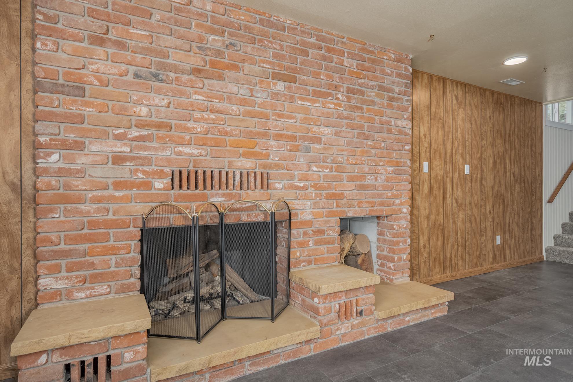 Brick fireplace with a stone hearth and integrated wood storage niche