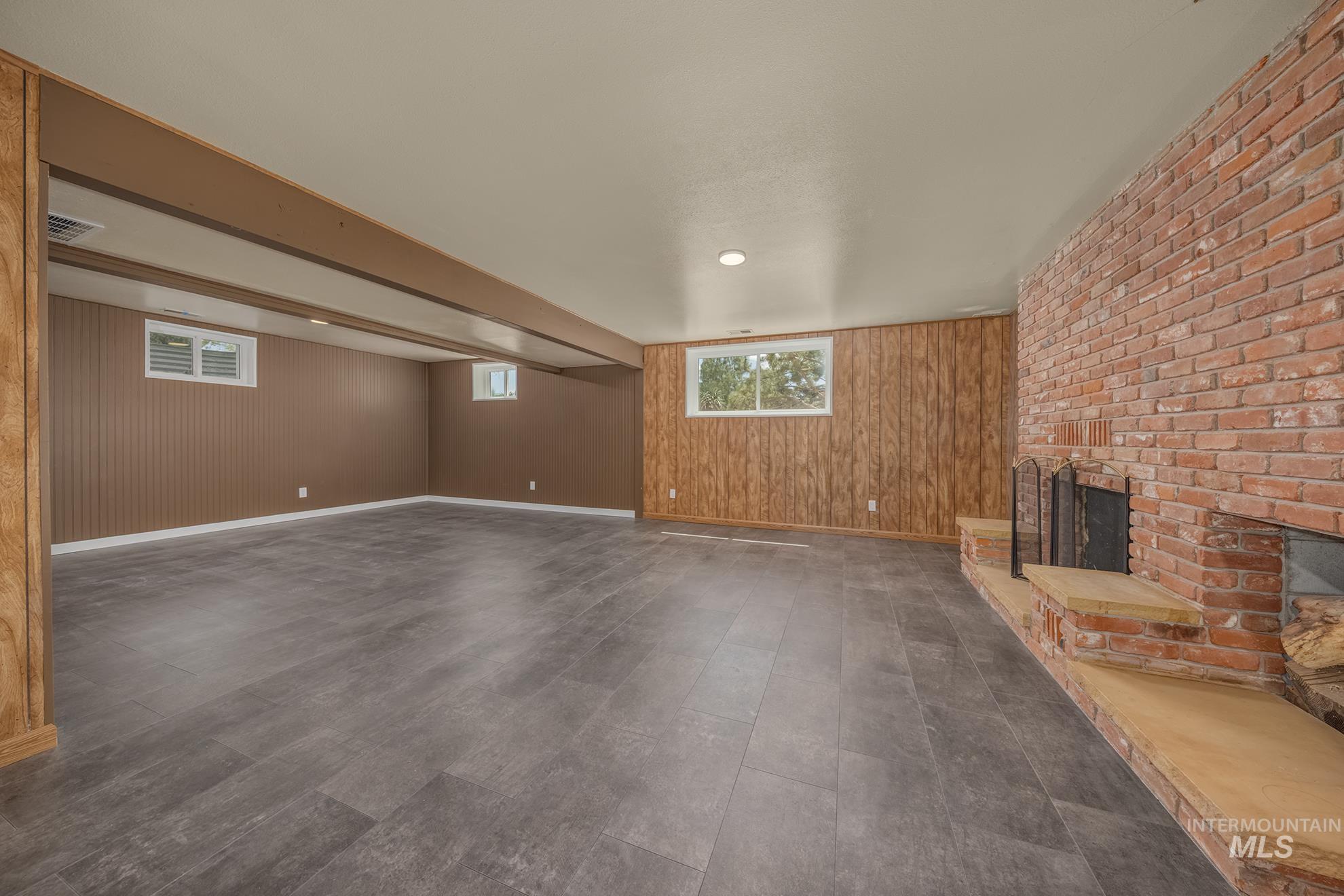 Spacious interior with textured brown paneling and wood-finish accent walls