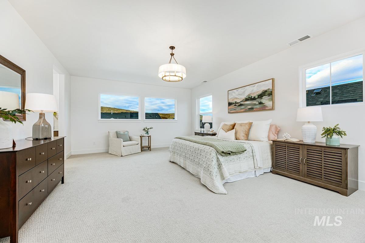 Bedroom with light carpet and baseboards