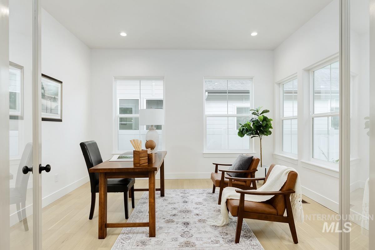 Office with light wood-style floors, plenty of natural light, recessed lighting, and french doors