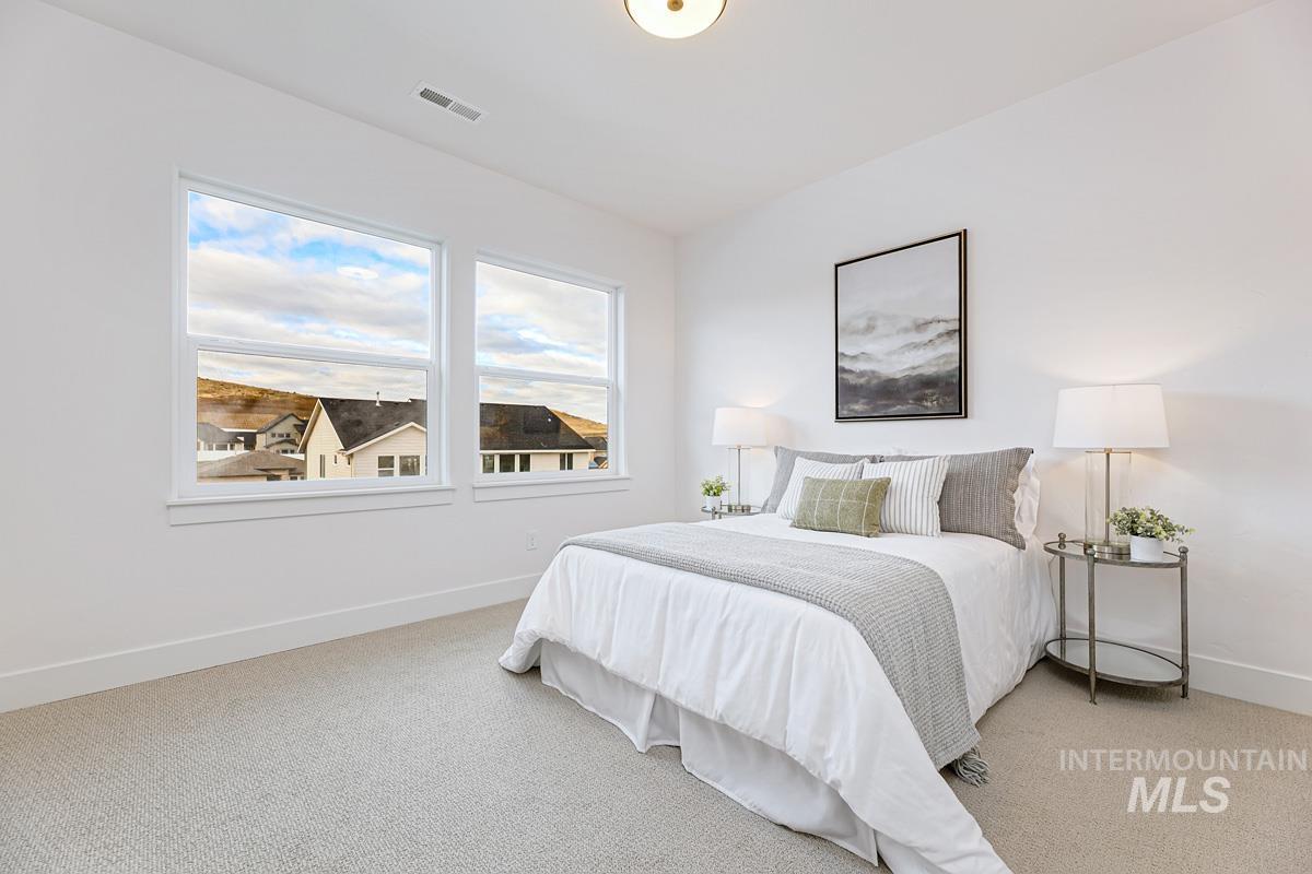Carpeted bedroom featuring baseboards