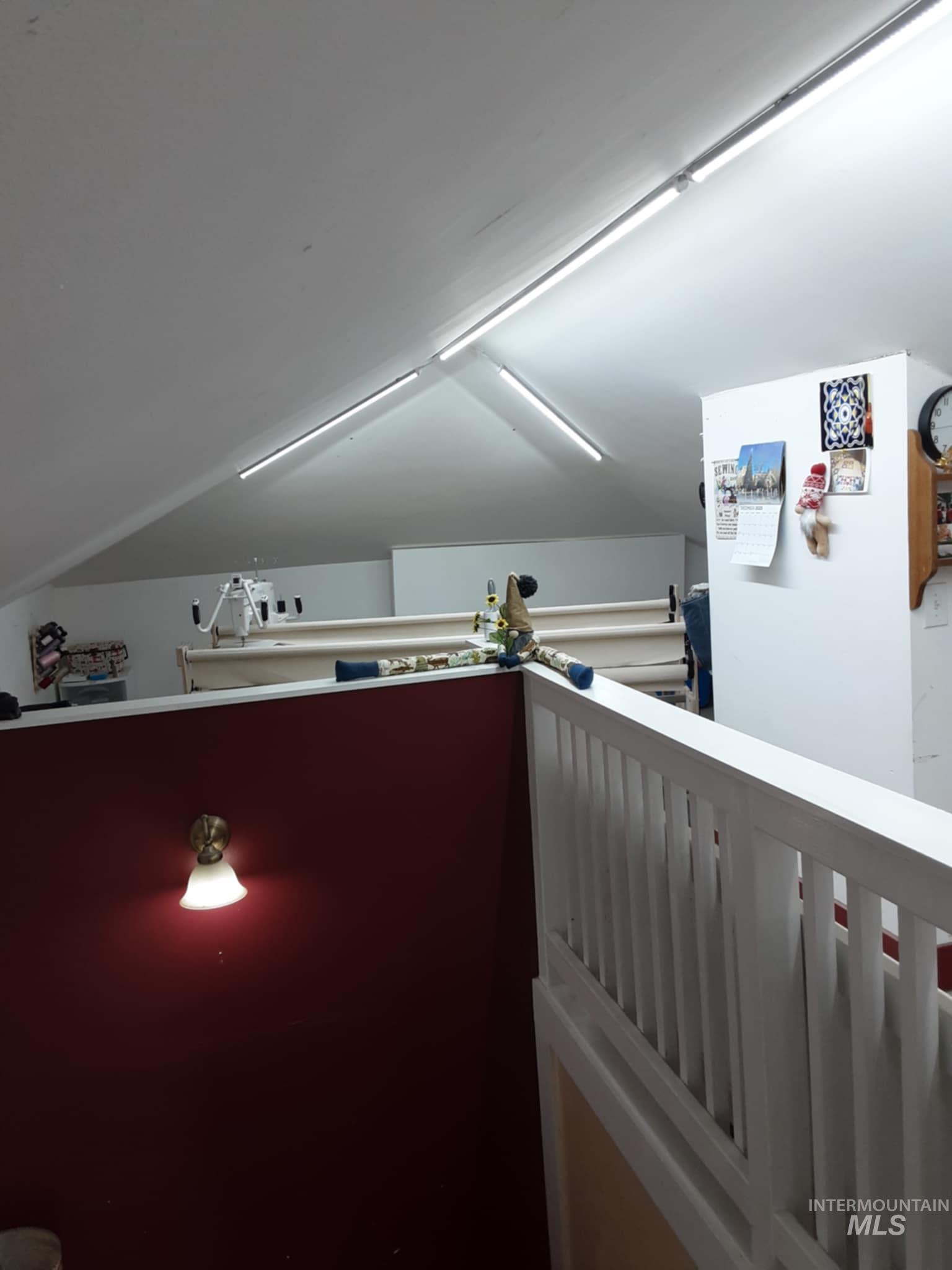 Hall with an upstairs landing and vaulted ceiling