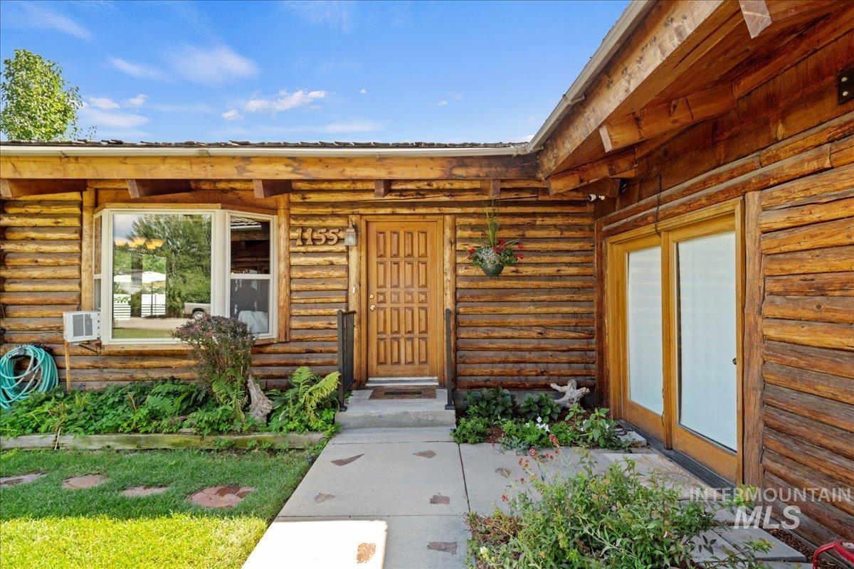 Property entrance featuring log siding