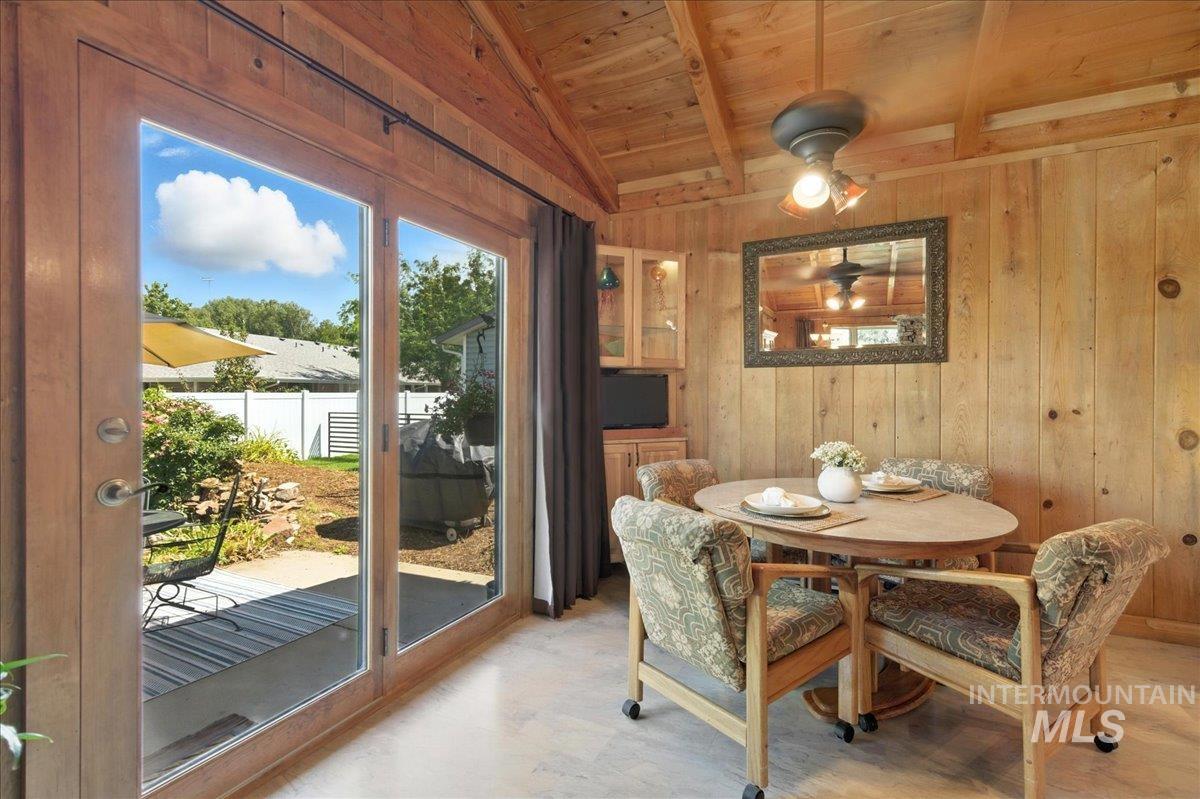 Dining space with wood ceiling and wooden walls