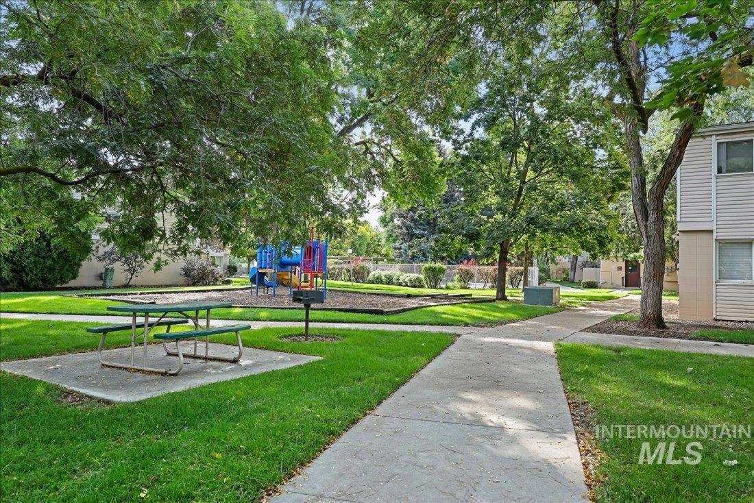 View of home's community with a yard