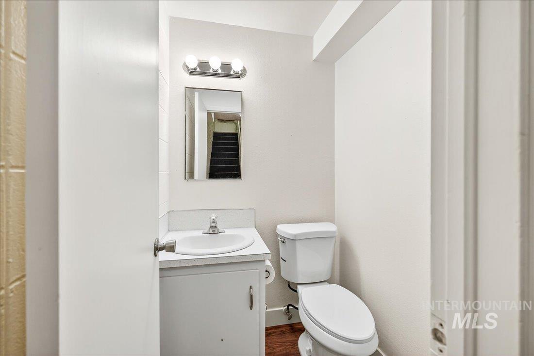 Bathroom with vanity and dark wood-type flooring
