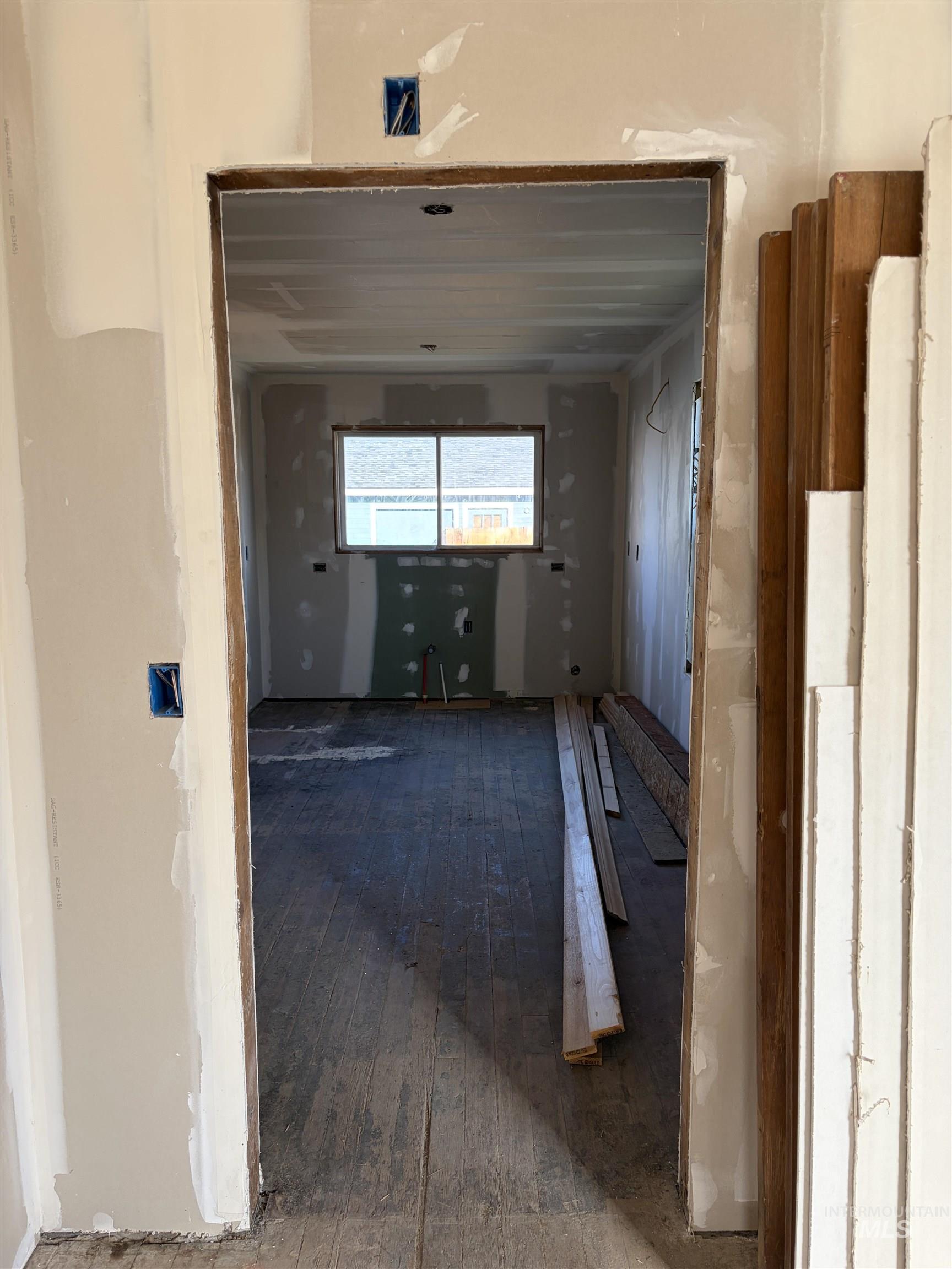 Corridor featuring dark wood-style flooring