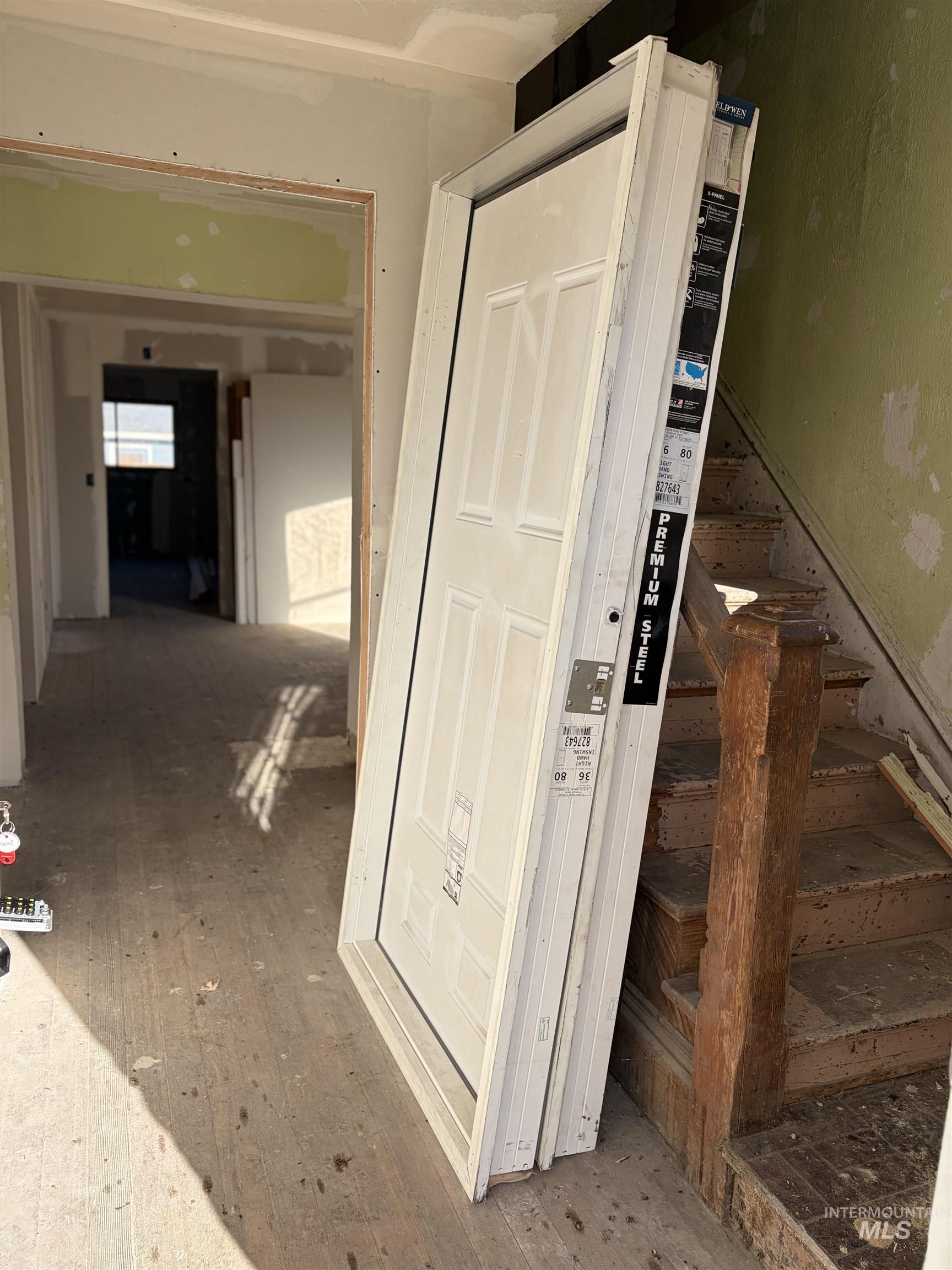 Hallway with hardwood / wood-style floors