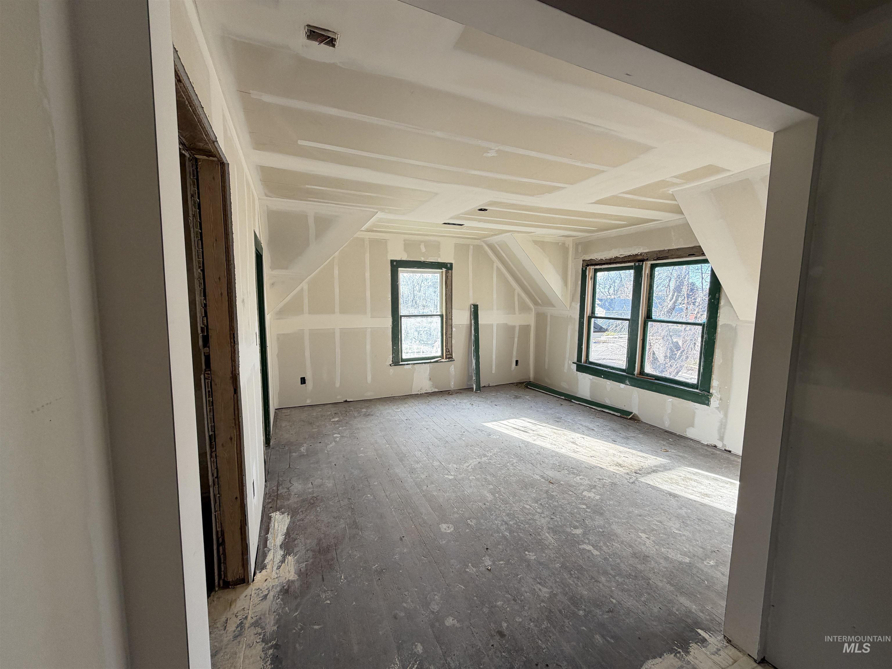 Additional living space featuring lofted ceiling