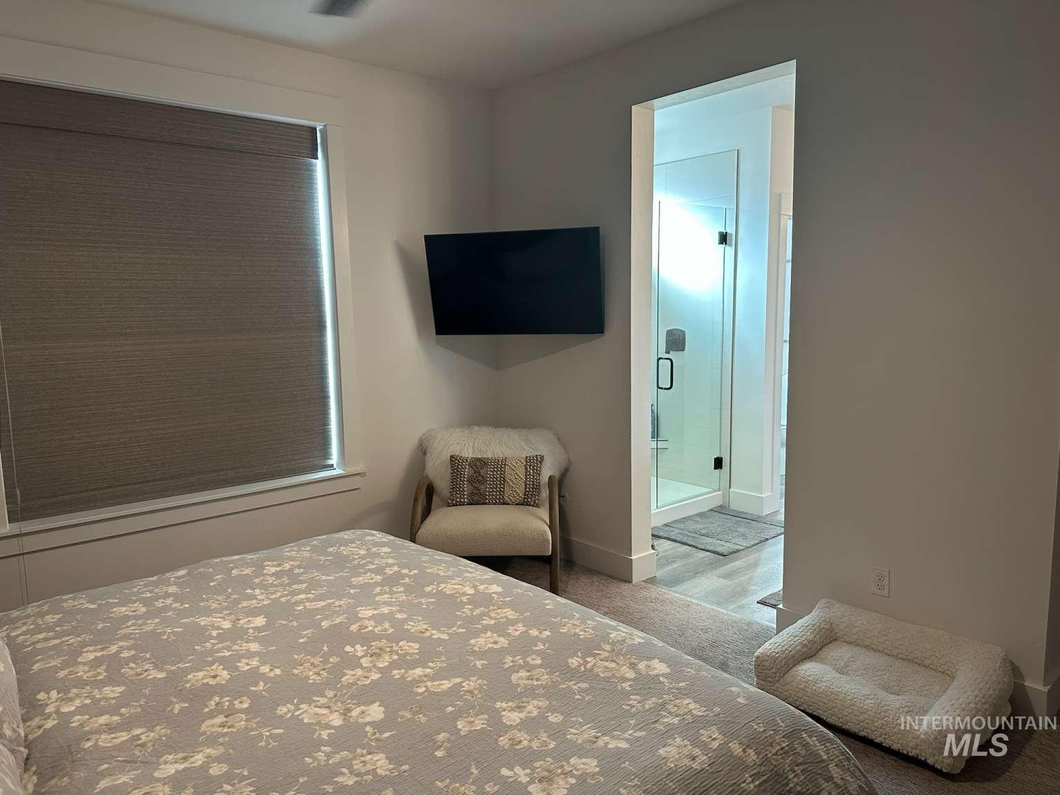 Bedroom with ensuite bathroom and carpet