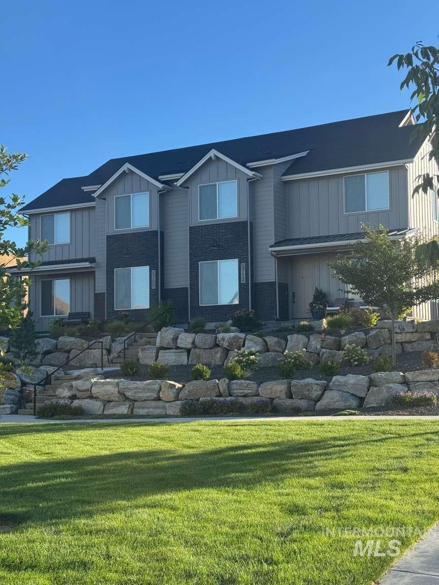 View of home's community with a yard