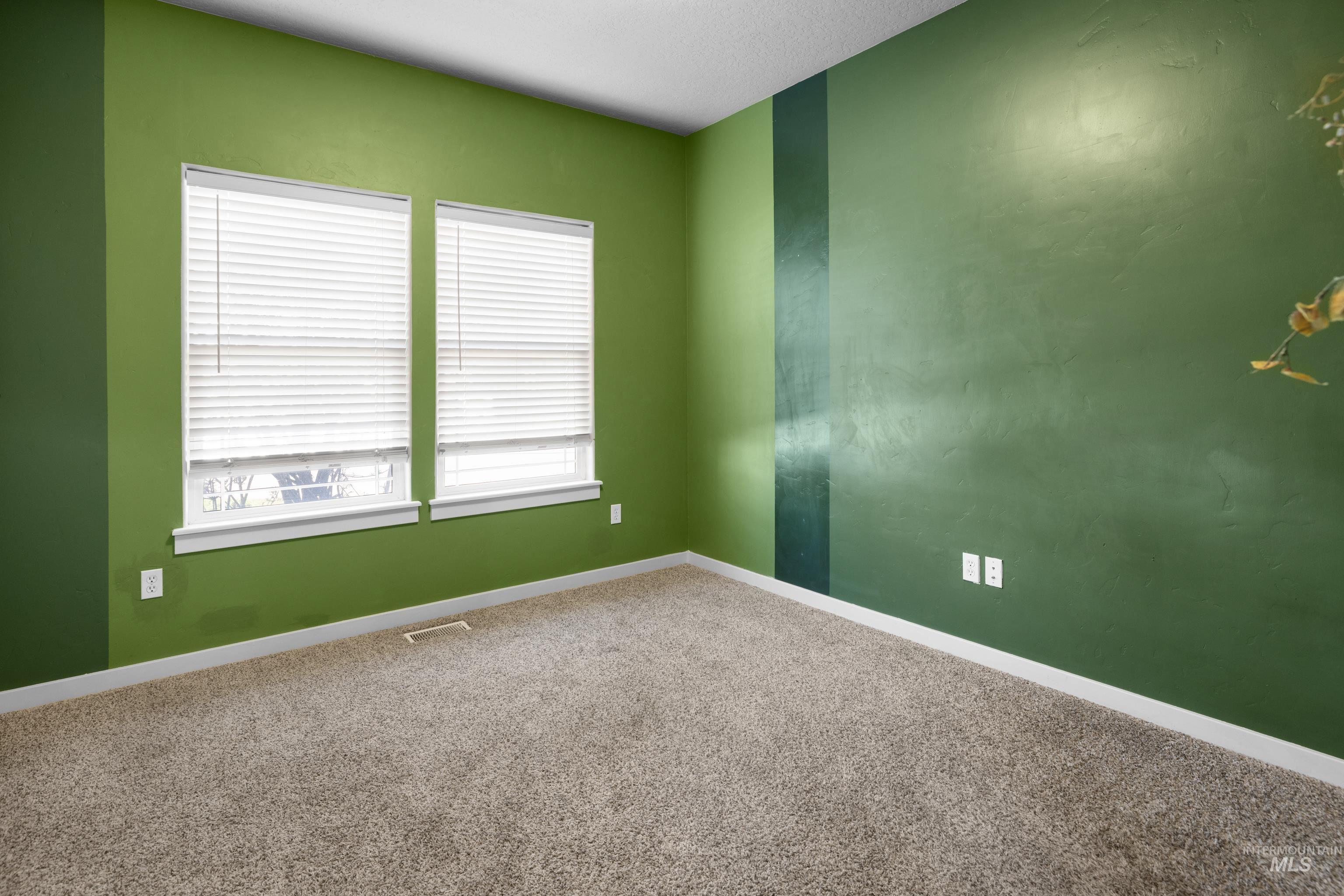 Empty room with baseboards and carpet
