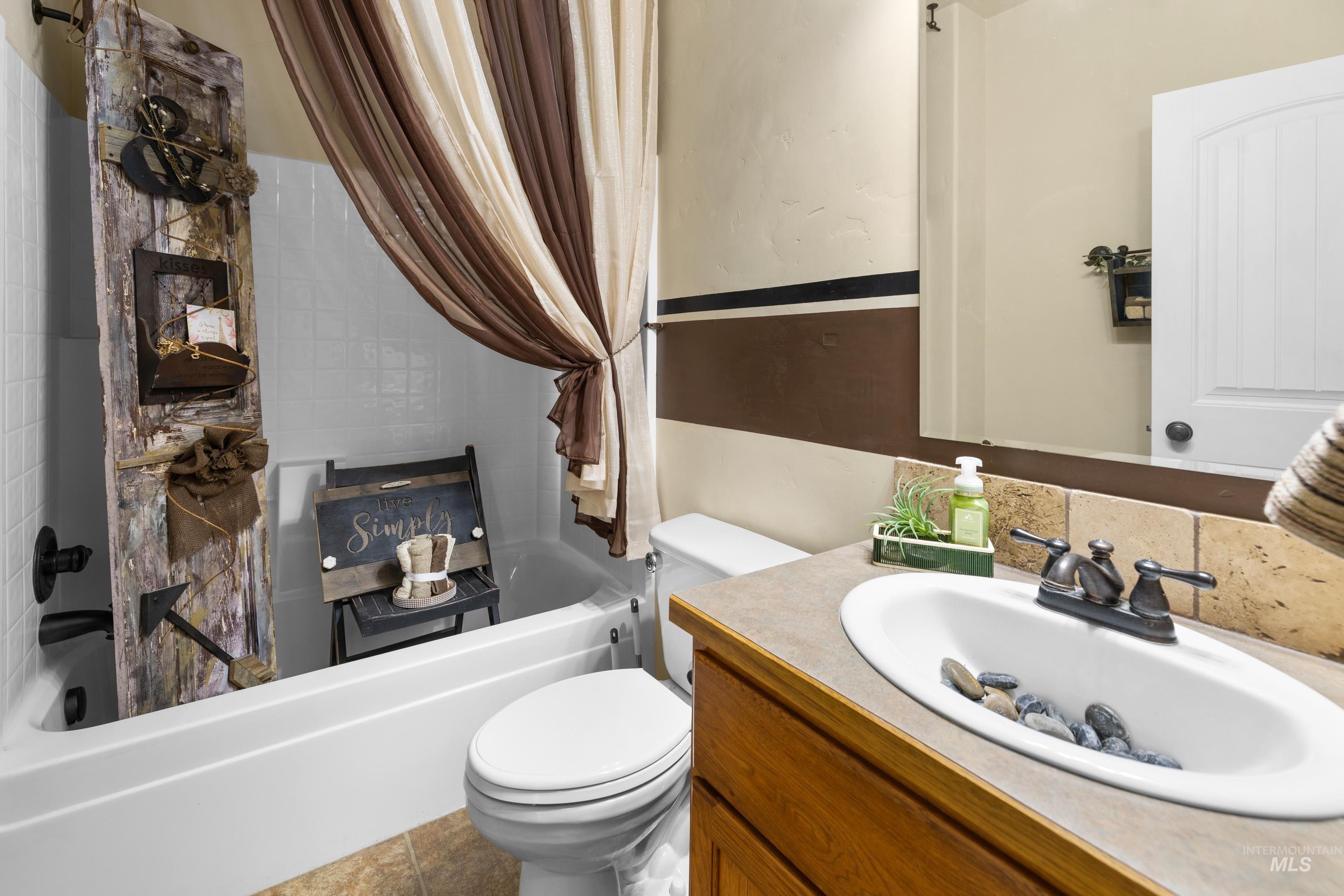 Full bathroom with vanity and shower / bath combo with shower curtain